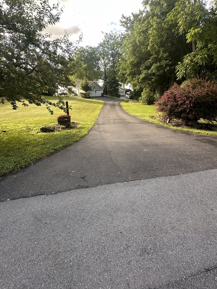 Paved driveway leading downhill toward the lakefront access path