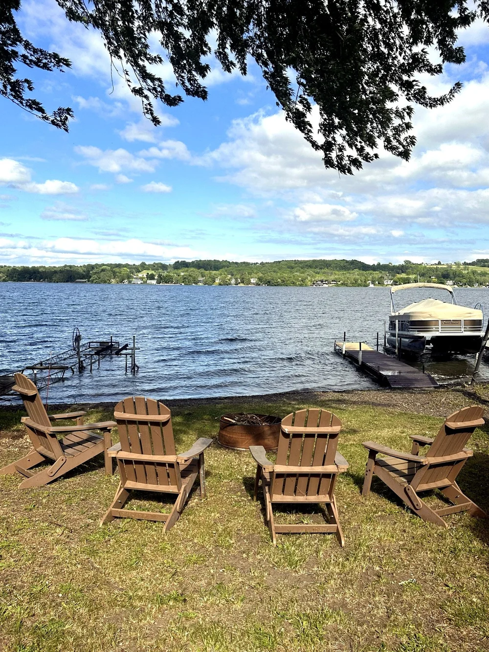 Waterfront fire pit and Adirondack chairs by Keuka Lake