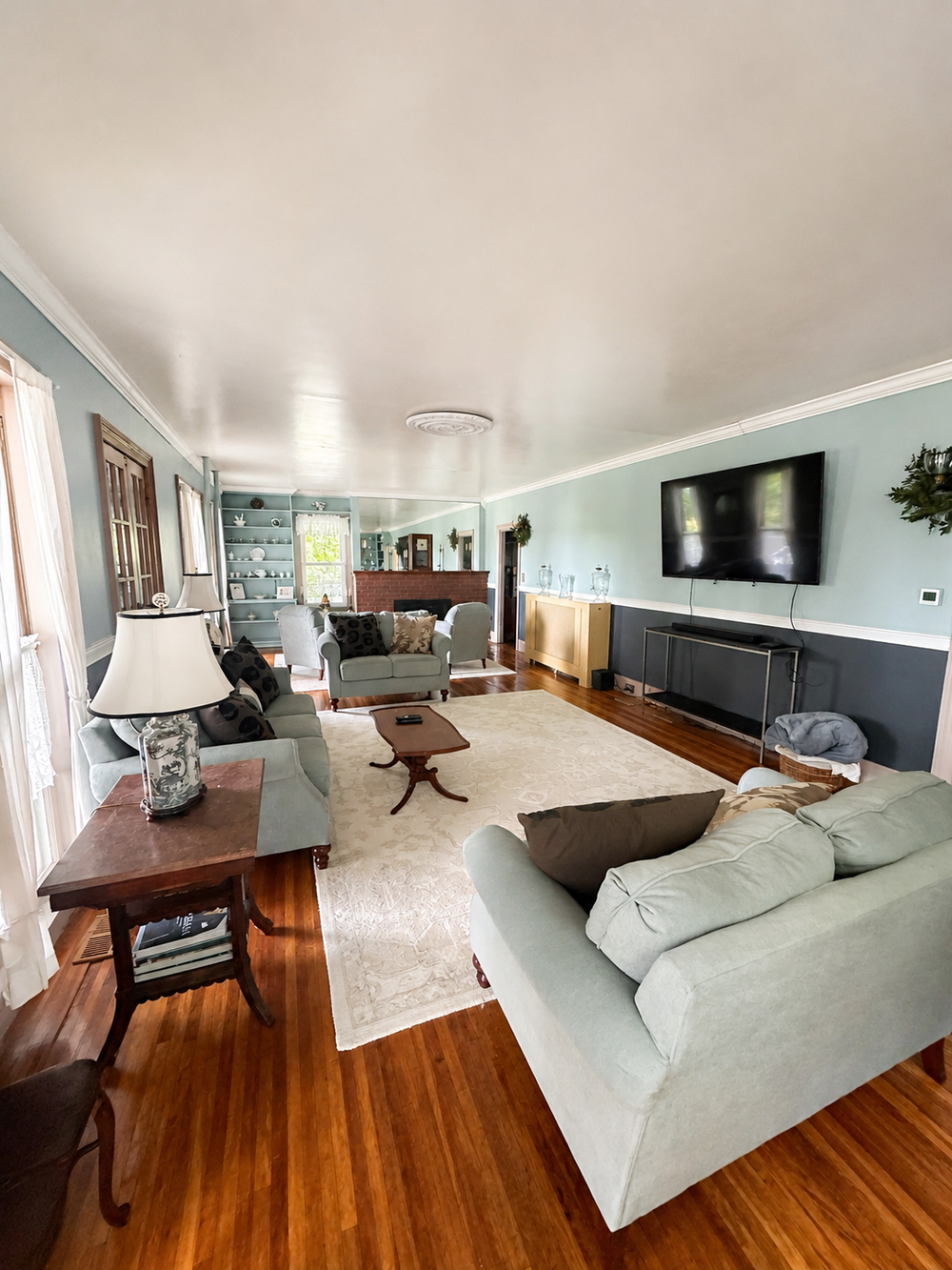 Unit 1 living room view showing TV, fireplace, and group seating