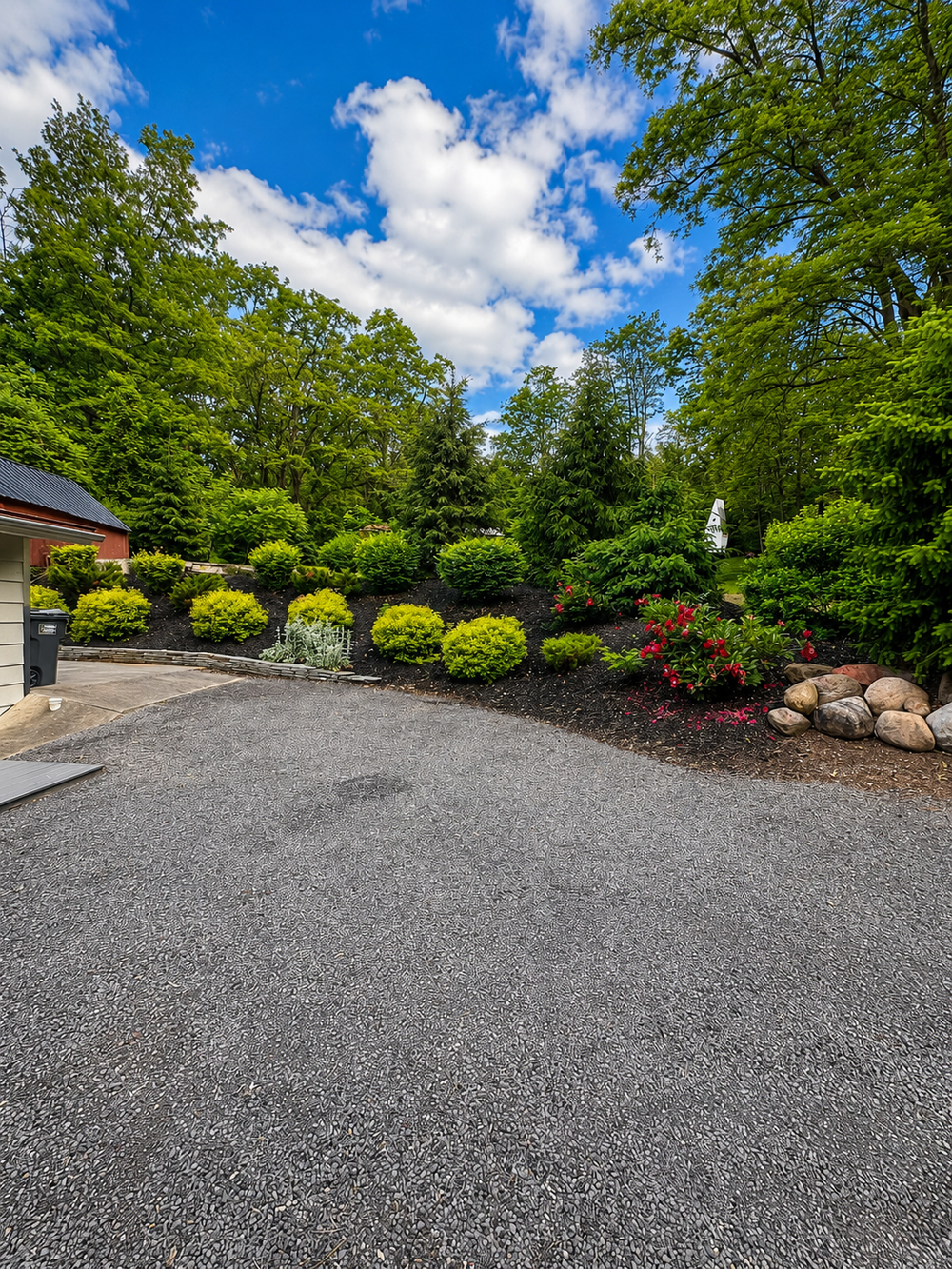 Back driveway parking area with landscaped grounds at Keuka Cove House