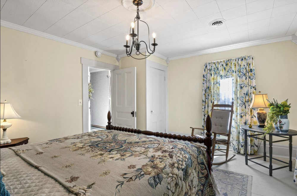 Unit 1 Bedroom 3 full room view with queen bed, dresser, and natural light