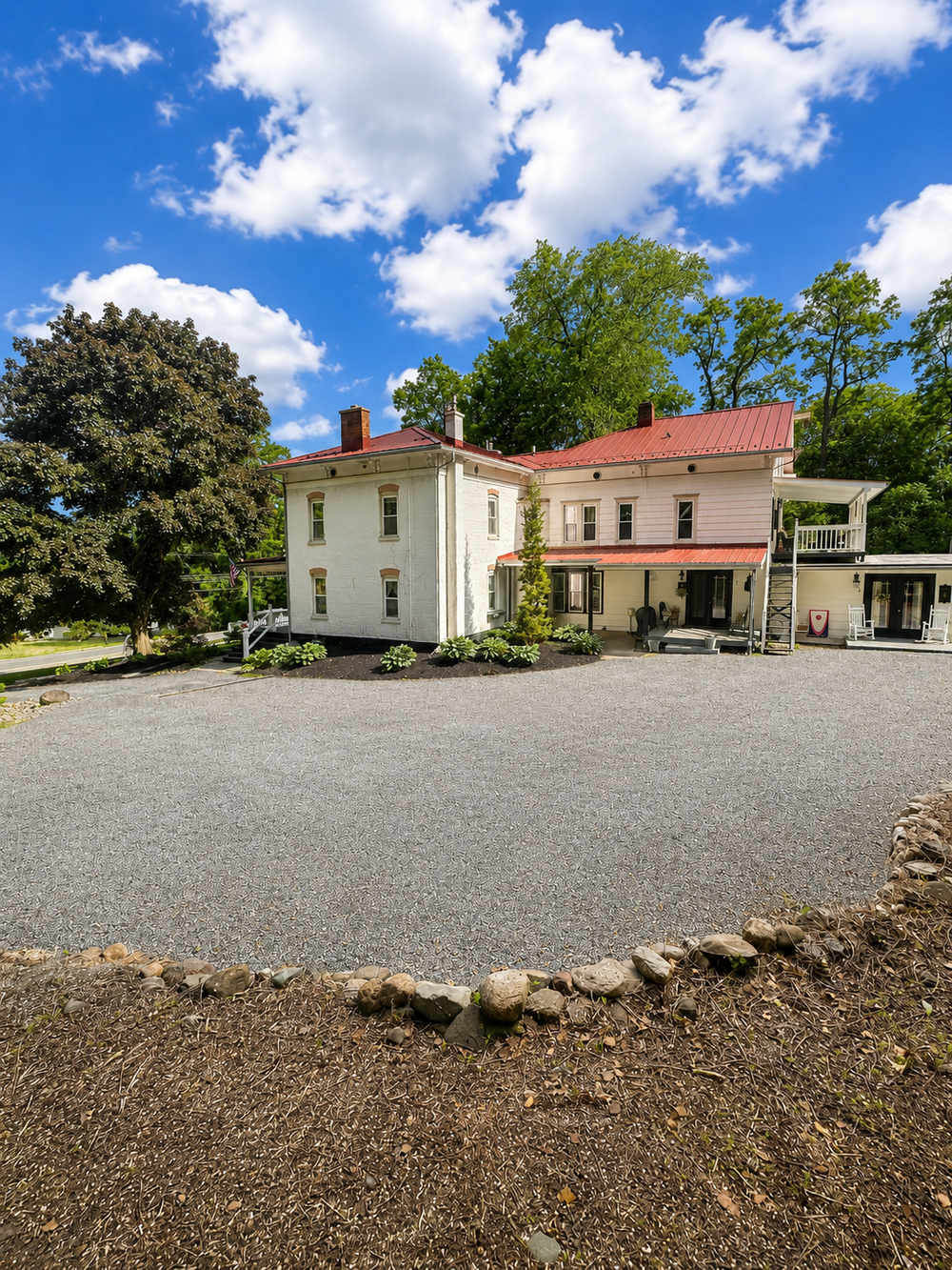 Wide gravel parking area beside Keuka Cove House