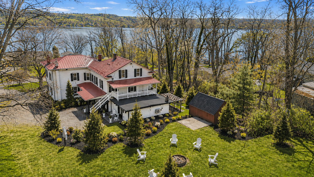 Aerial view of Keuka Cove House showing the backyard decks driveway and surrounding grounds