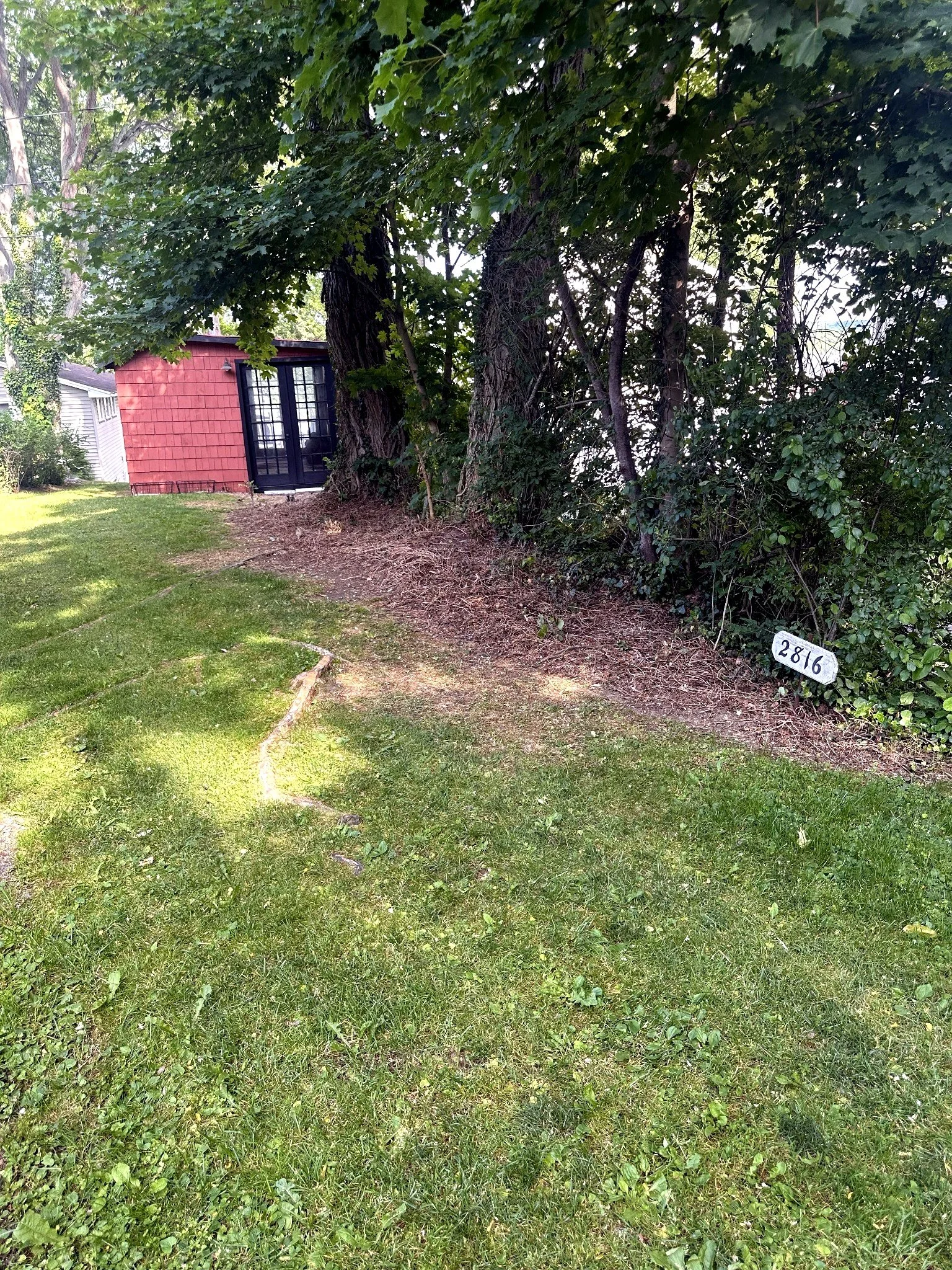Marked grass walkway near the 2816 sign leading to the boathouse lounge and lakefront