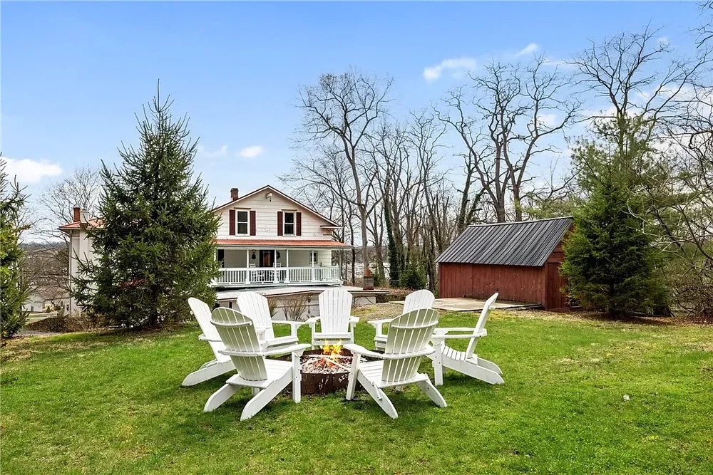Backyard fire pit seating area with views back toward Keuka Cove House