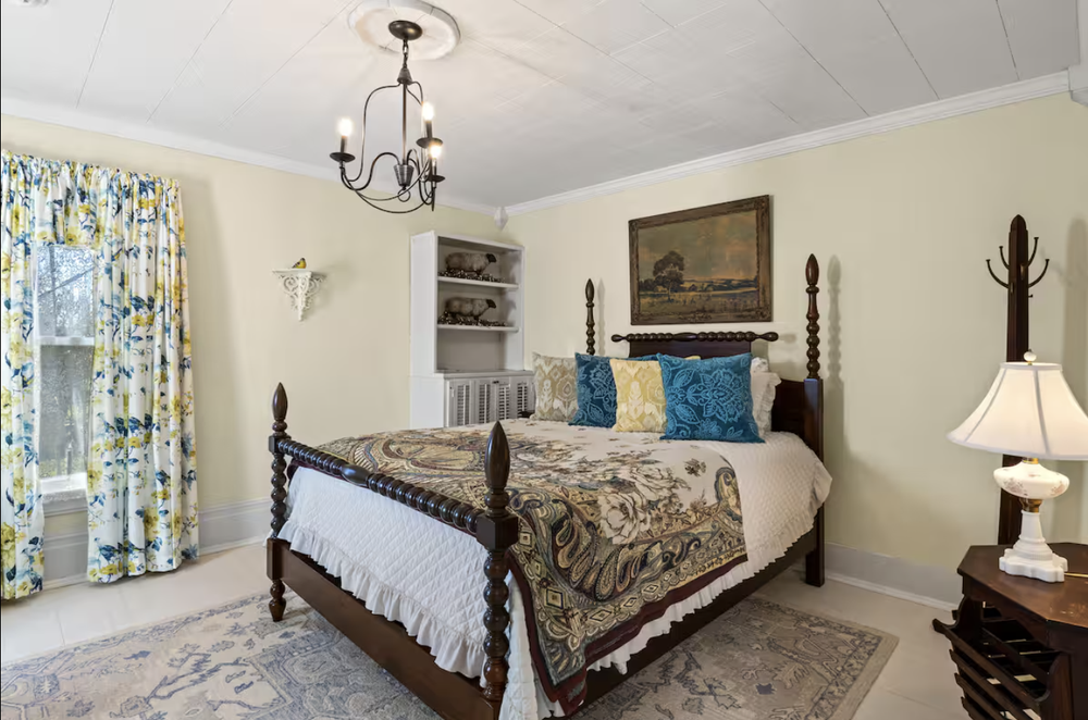 Unit 1 Bedroom 3 with queen bed, window seating area, and classic upstairs layout
