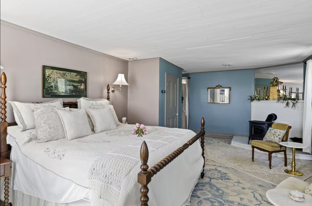 Unit 1 Bedroom 1 king bed side view with sitting area and classic main house charm