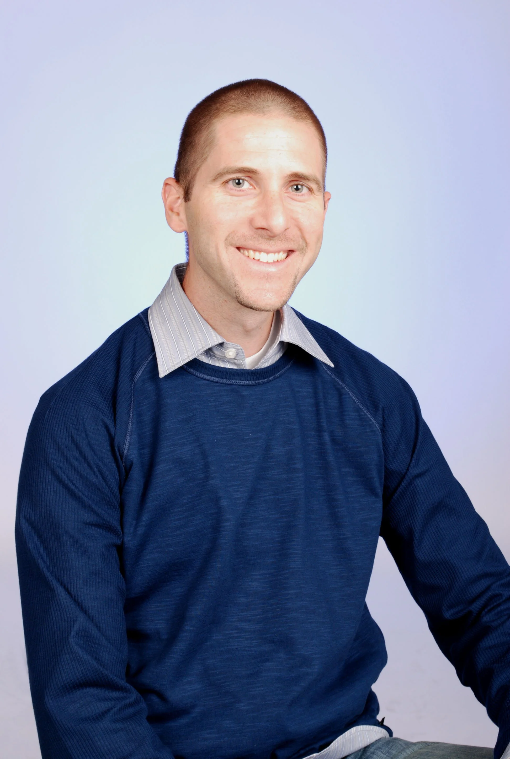 Picture of Dr. White in blue shirt smiling