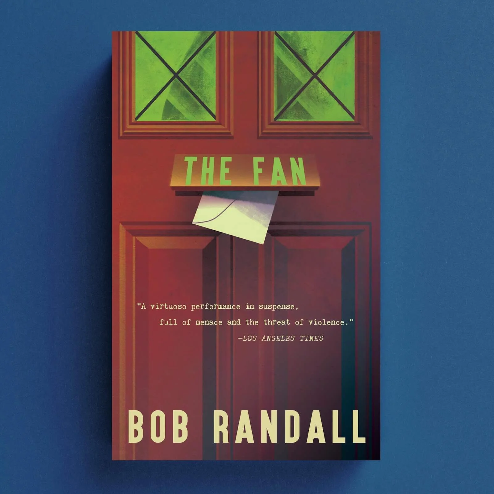 Cover for The Fan featuring a red front door with an envelope beneath green windows