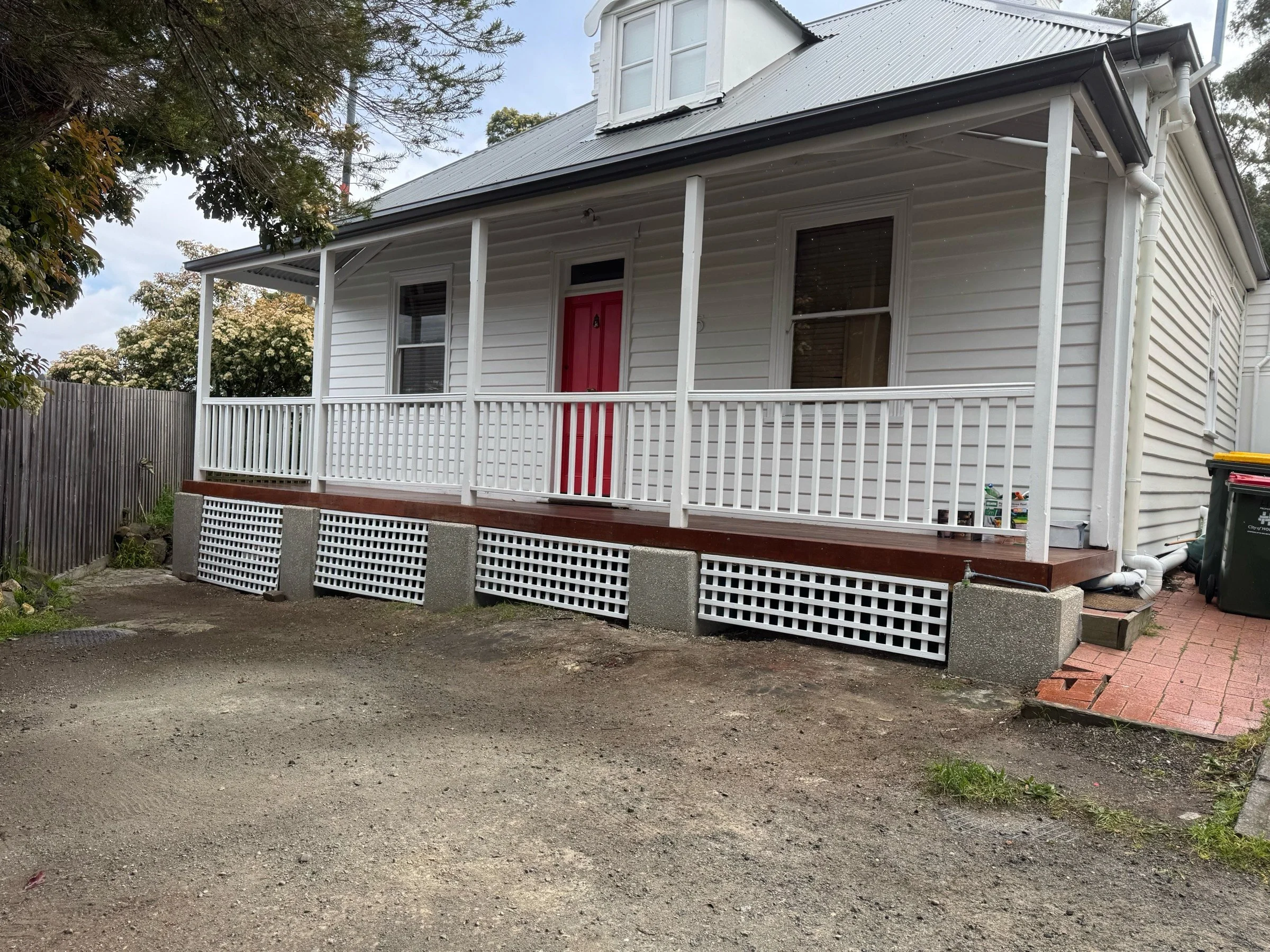 Freshly installed and painted railing and latticework on Tasmanian weatherboard home