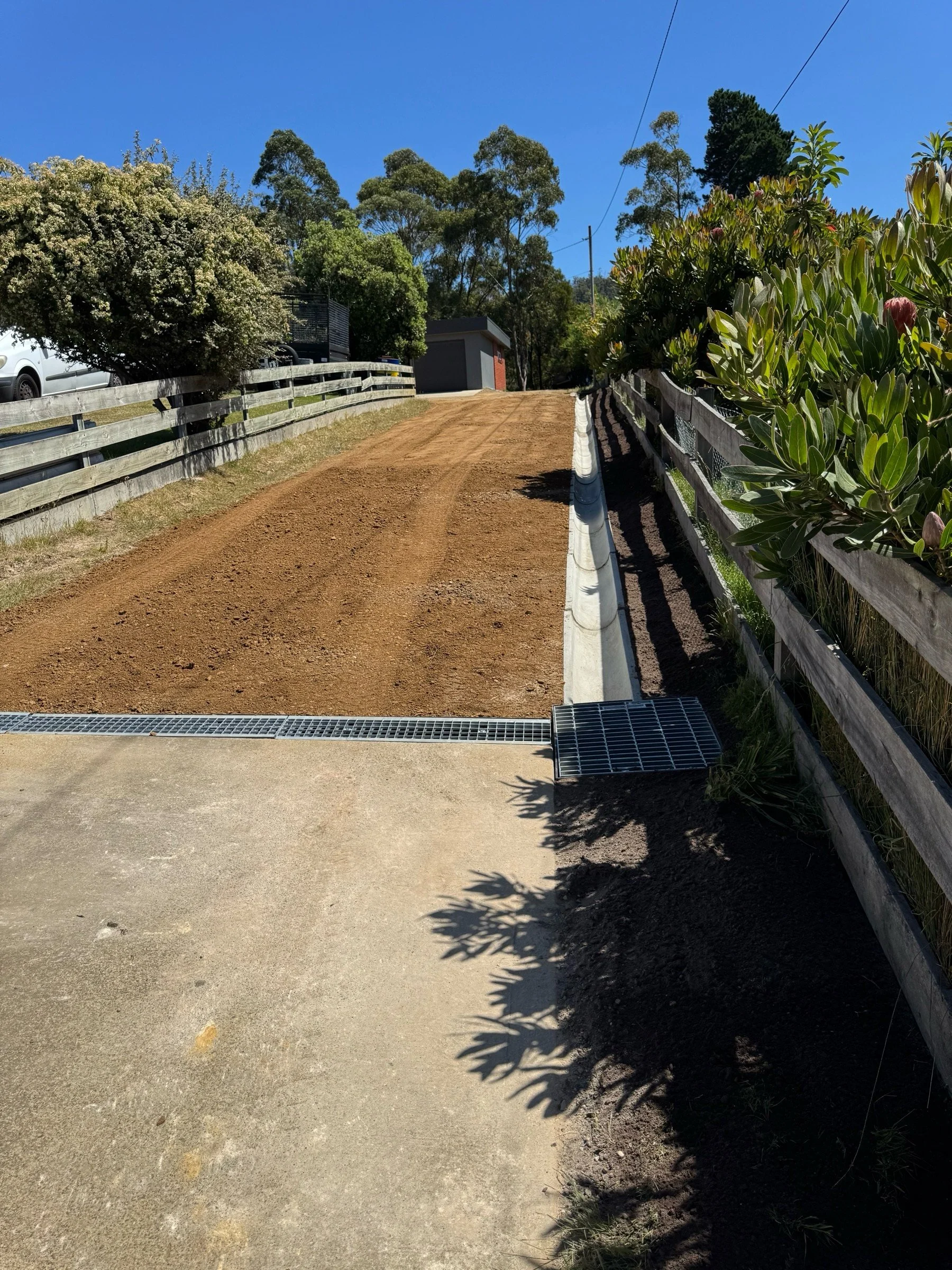 Freshly installed stormwater irrigation along driveway