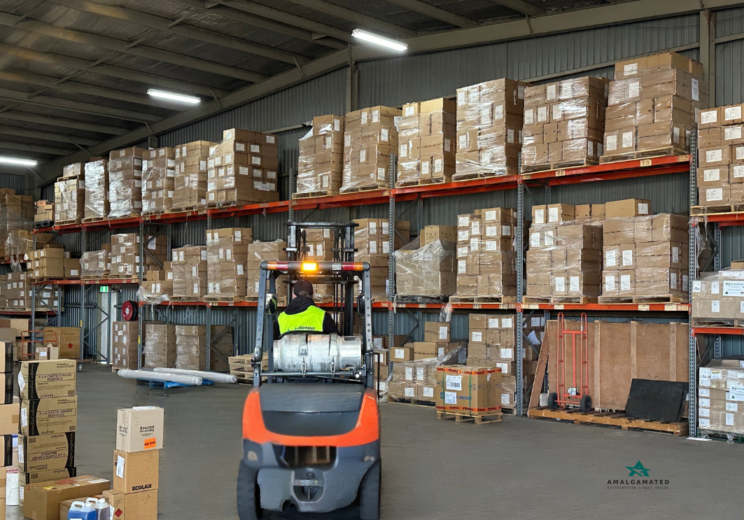 Metrans warehouse with palletised freight and a forklift operator