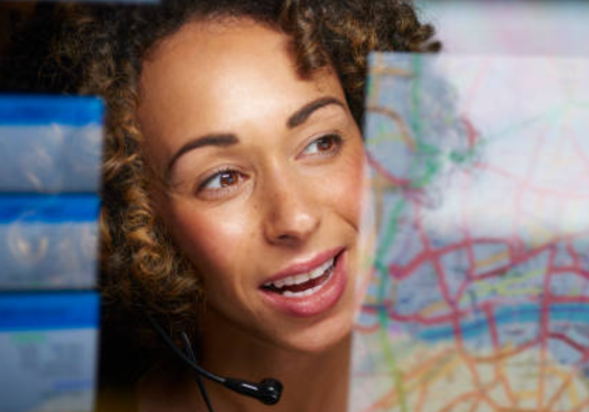 Metrans customer service team member wearing a headset beside a delivery map