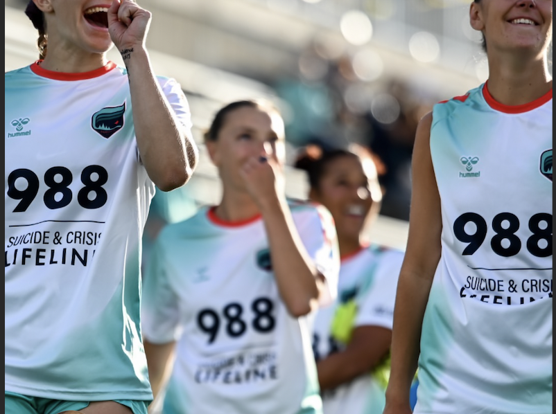 image shows soccer players wearing 988 partnership jerseys with the MN Aurora FC