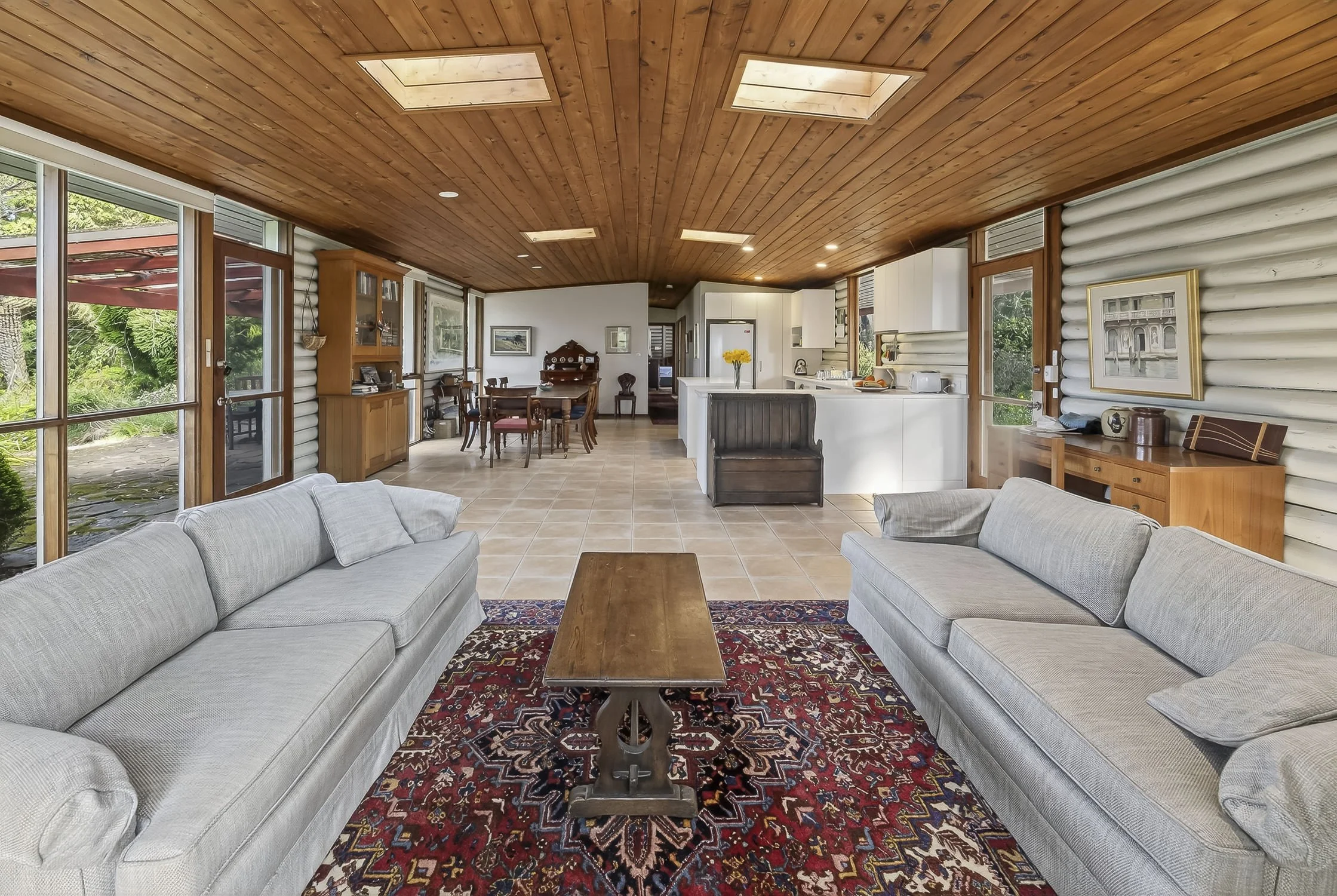 Open plan living area, kitchen and dining areas in a rustic cabin in the Blue Mountains