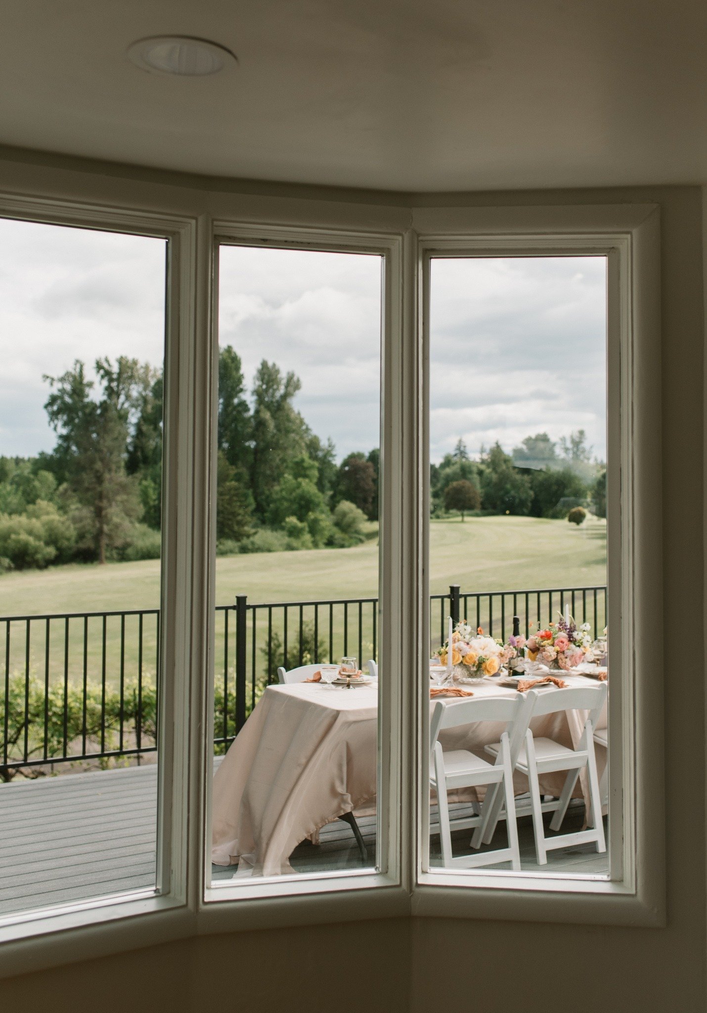 Small dinner table seen through the manor bay window at The Preserve in McMinnville, Oregon