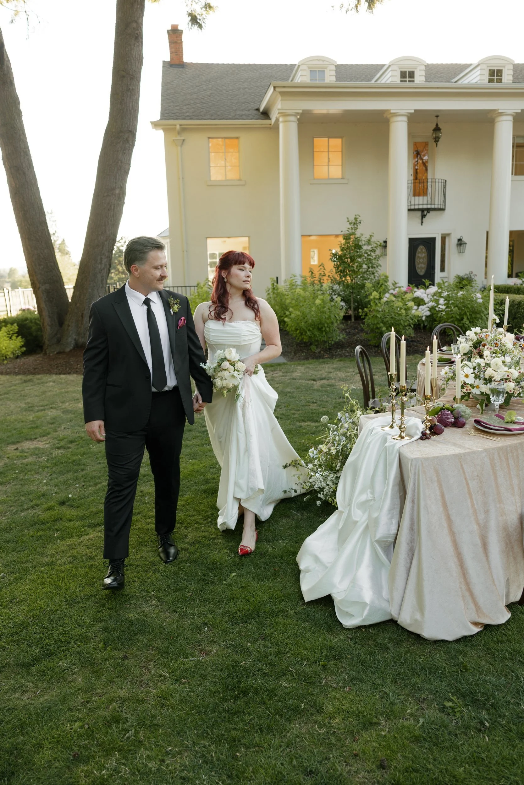 Bride and groom walking past their intimate garden dinner table at The Preserve in McMinnville, Oregon