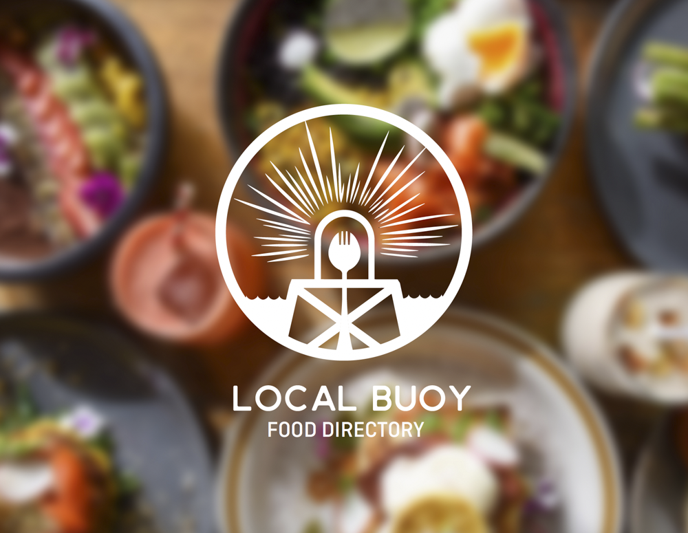 Assorted bowls of colorful salads and dishes on a wooden table, with a logo for Local Buoy Food Directory in the foreground.