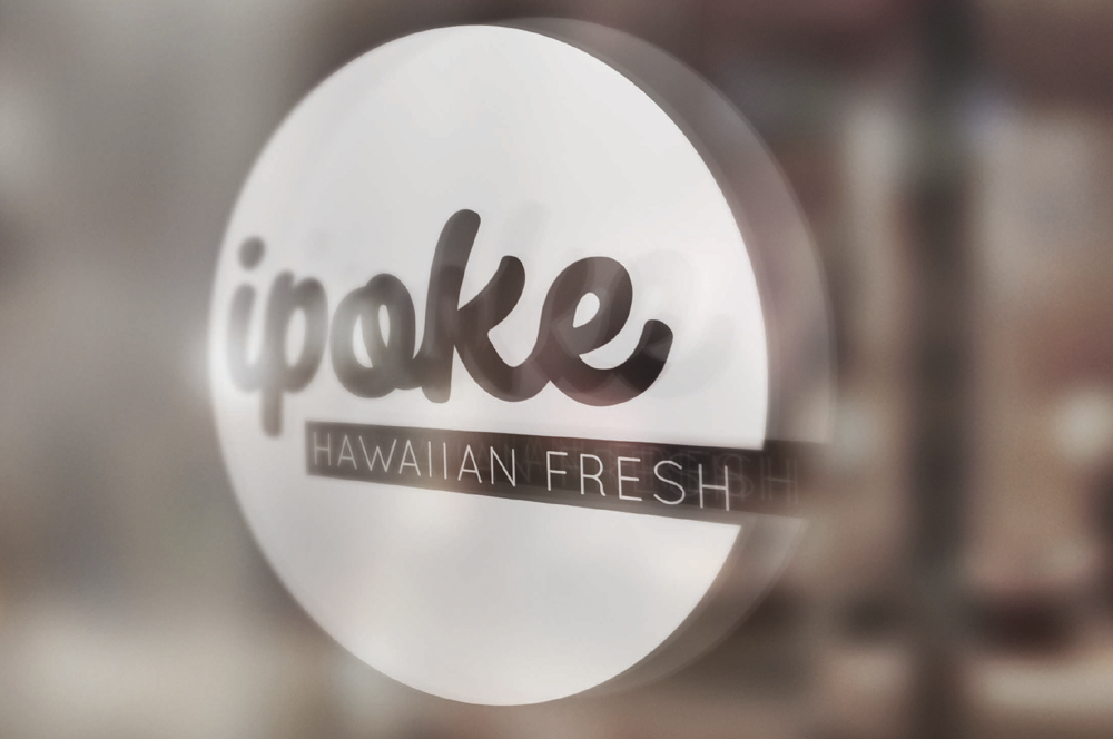 Close-up of a circular sign with the word 'ipake' and the text 'Hawaiian Fresh' underneath, referring to a product or brand.