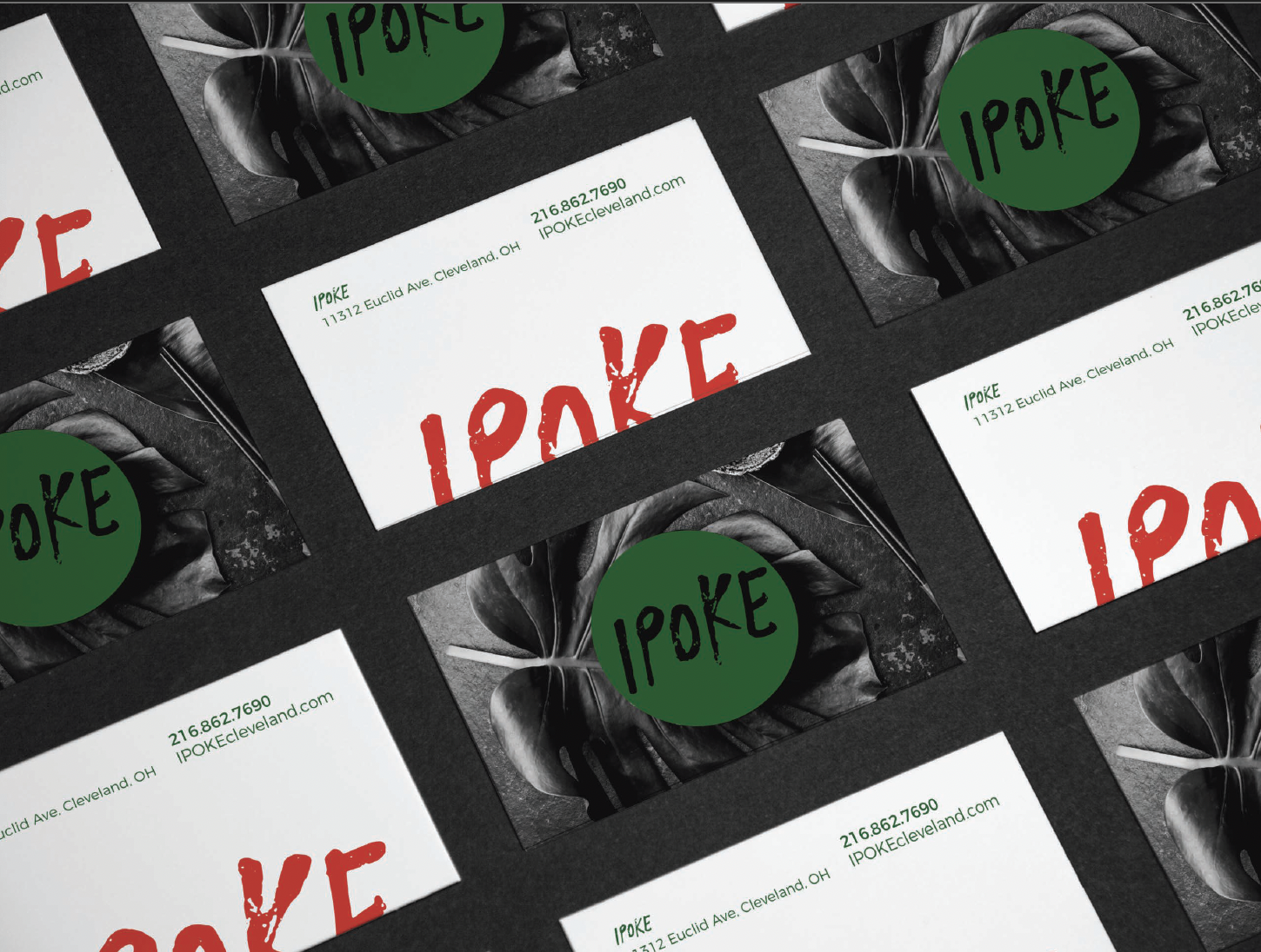 Multiple business cards for IPOKE with a black and white background featuring a large leafy plant, and a green circle with the black handwritten word 'IPOKE' on it, arranged in a grid.