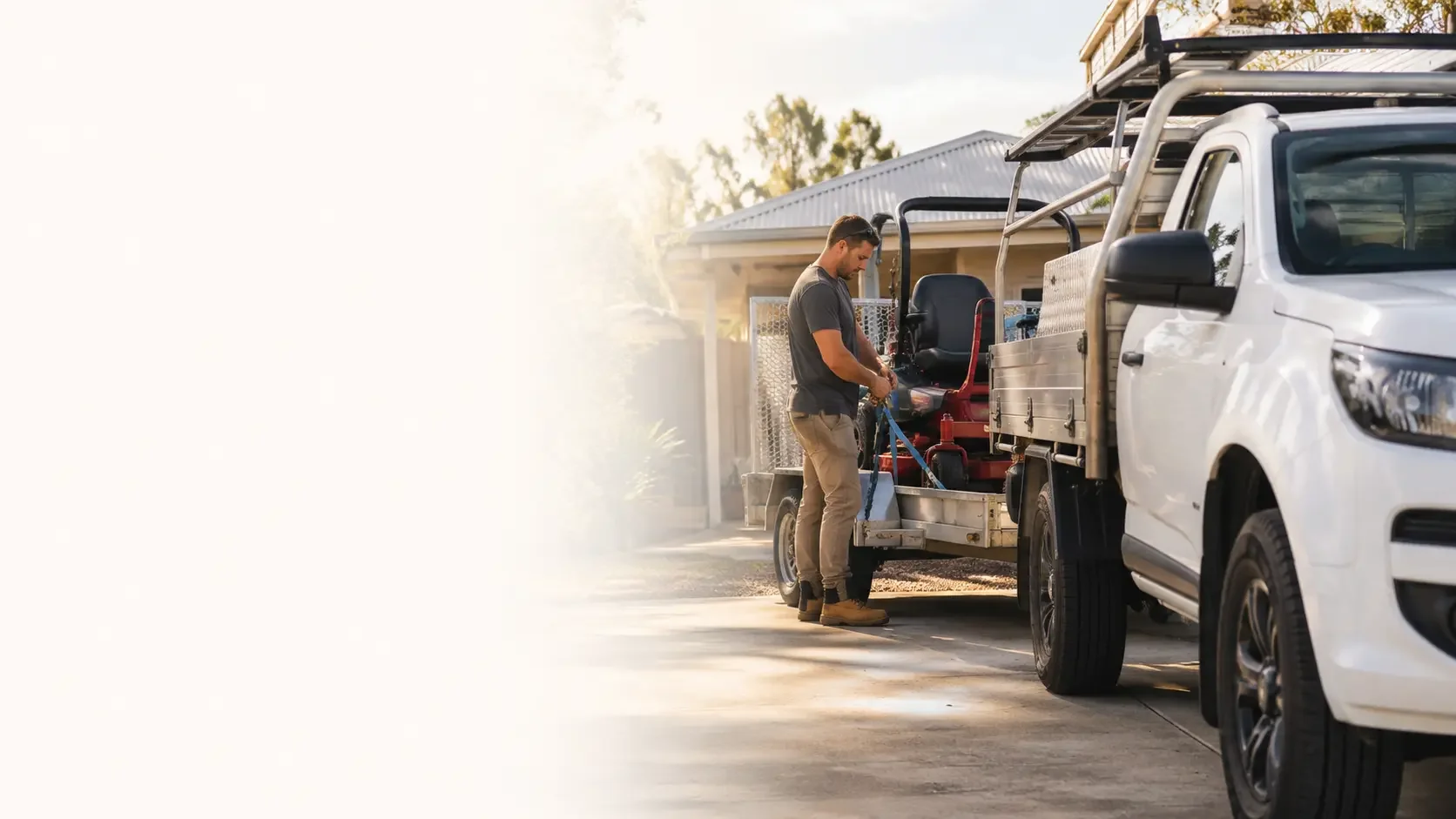 Worker loading tools near a ute representing work vehicle and equipment finance options.