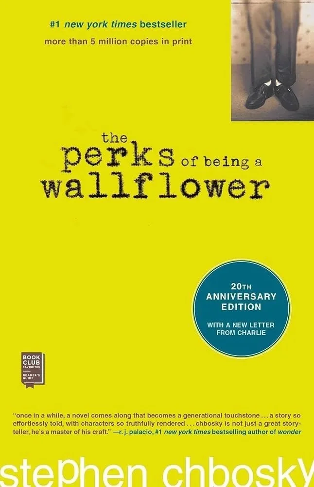 Book cover of 'The Perks of Being a Wallflower' by Stephen Chbosky, 20th anniversary edition, with a bright yellow background and a small photo of a person's legs and shoes in the upper right corner.