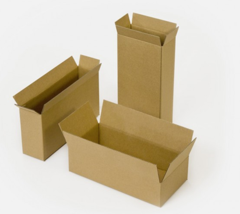 Three empty cardboard boxes on a white surface, two standing upright and one lying flat.