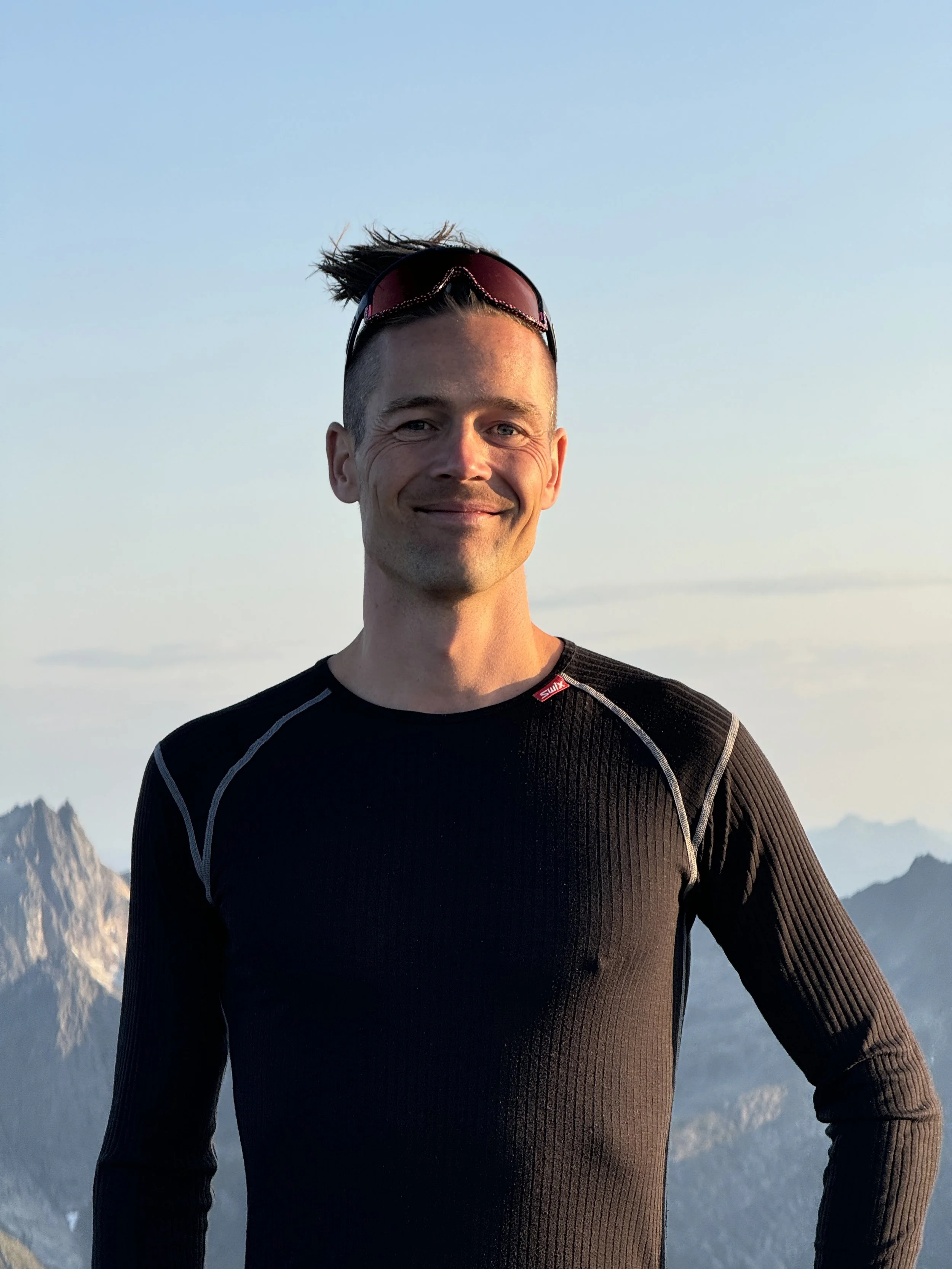 Founder of HeiTromsø standing in the Arctic landscape at sunset – passionate about nature, stories, and creating memorable guided experiences.