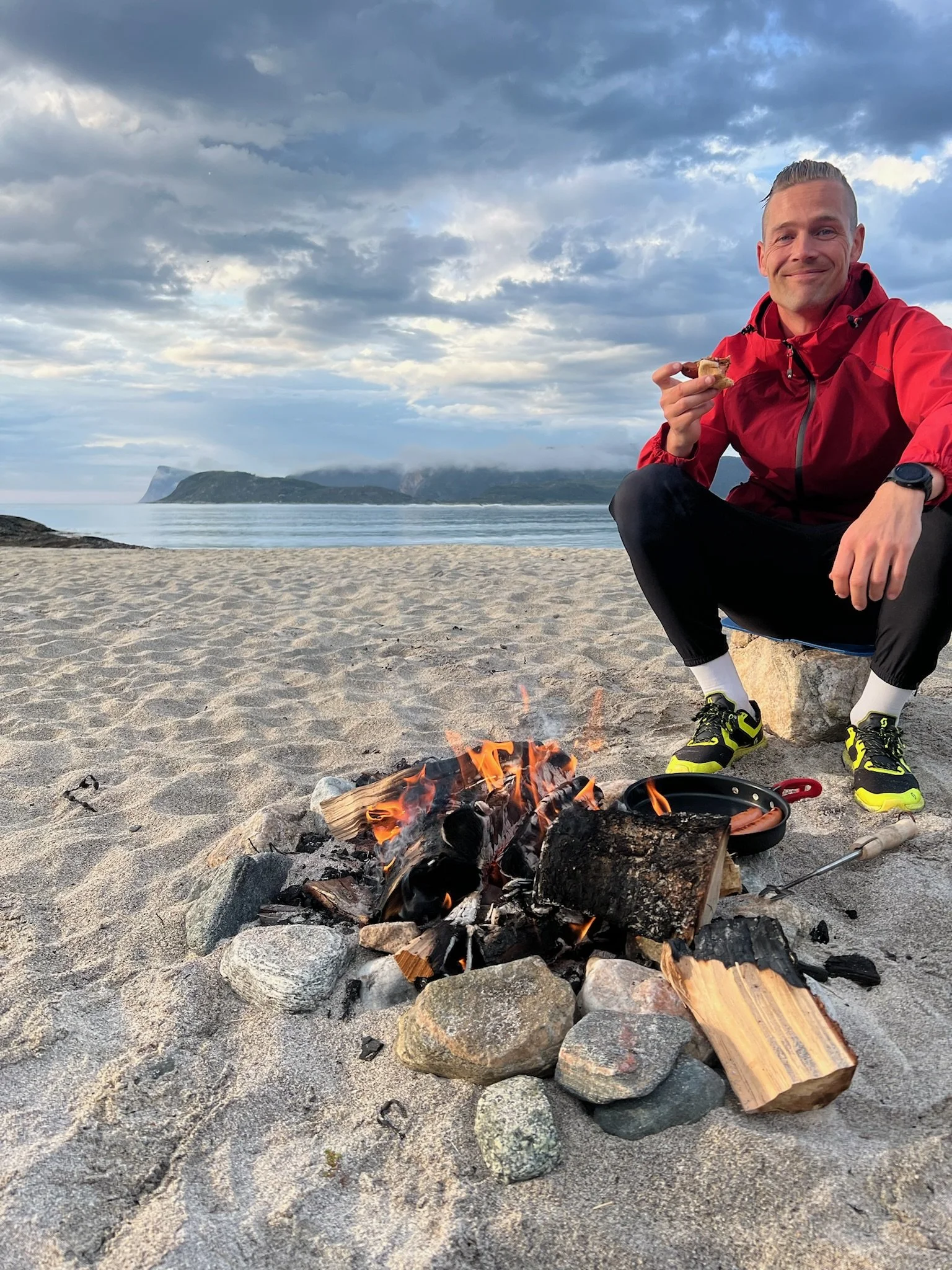 Local Tromsø guide enjoying a moment by the Arctic coast – sharing outdoor cooking and storytelling experiences on private tours.