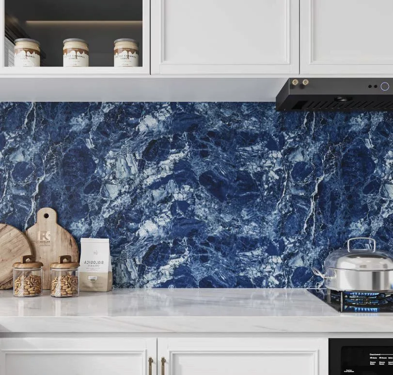 Kitchen countertop with a blue marble backsplash, white cabinetry, and a pot on the stove.