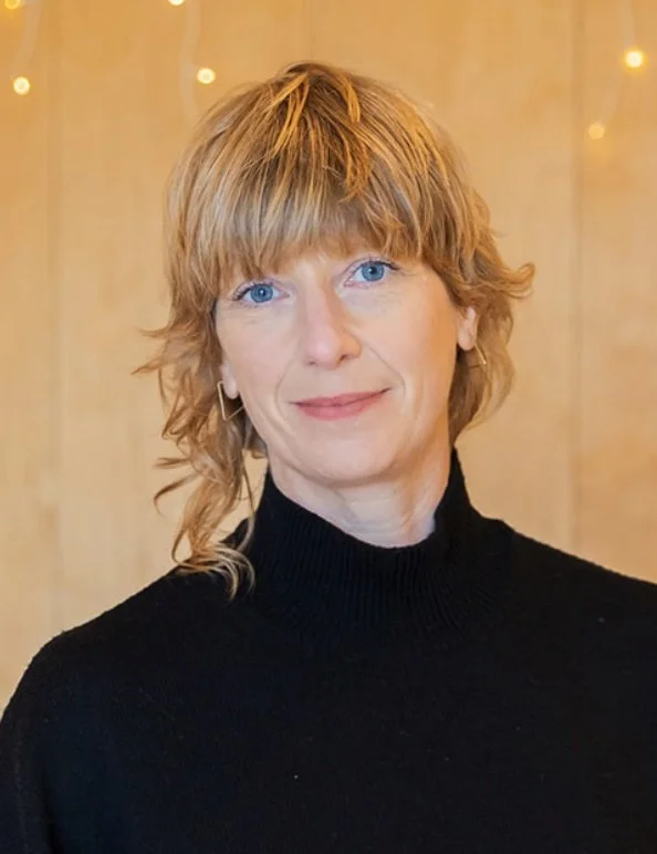 head and shoulers photo of white woman with golden blonde hair smiling