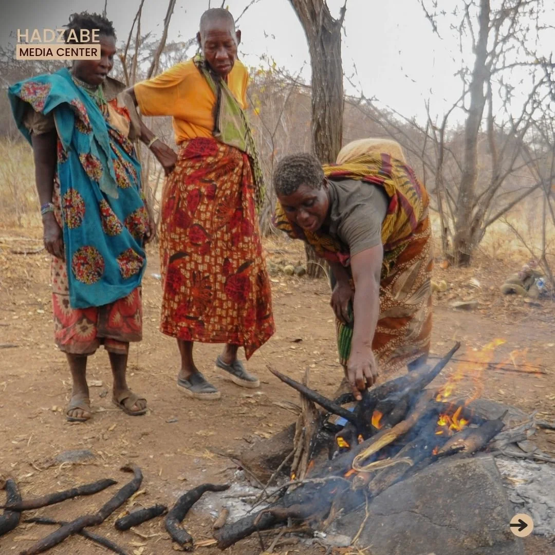 A picture showing a group of Hadzabe women fire roasting the dug roots