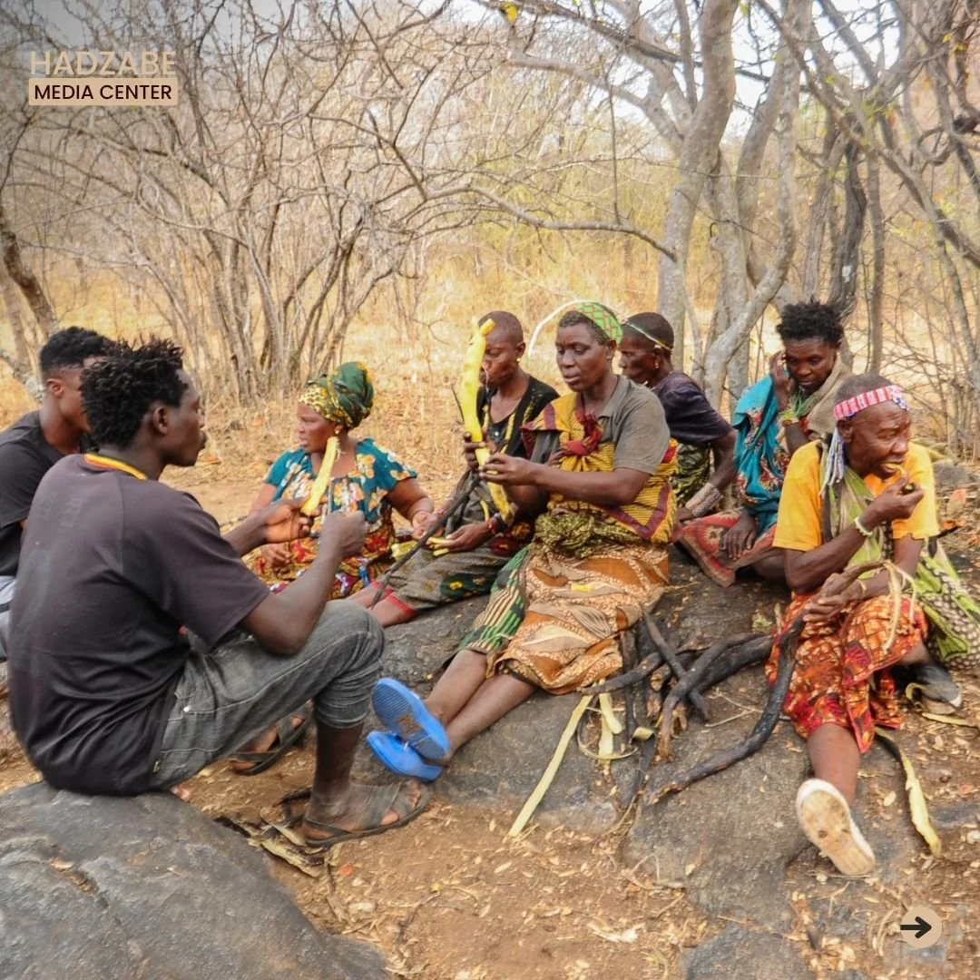 A picture showing some members of the Hadzabe Community enjoying to eat their foraged roots