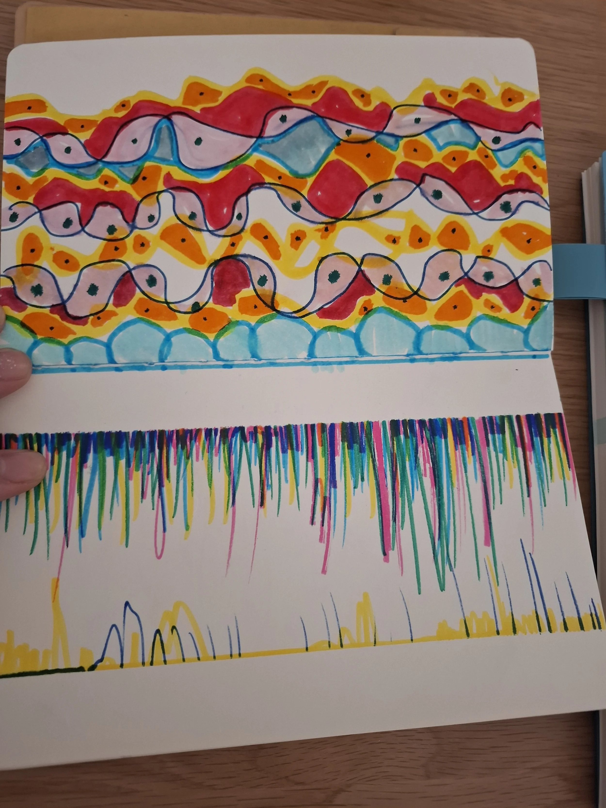 Colorful abstract drawing with wavy lines, dots, and streaks in red, yellow, pink, blue, black, and green on a white background.