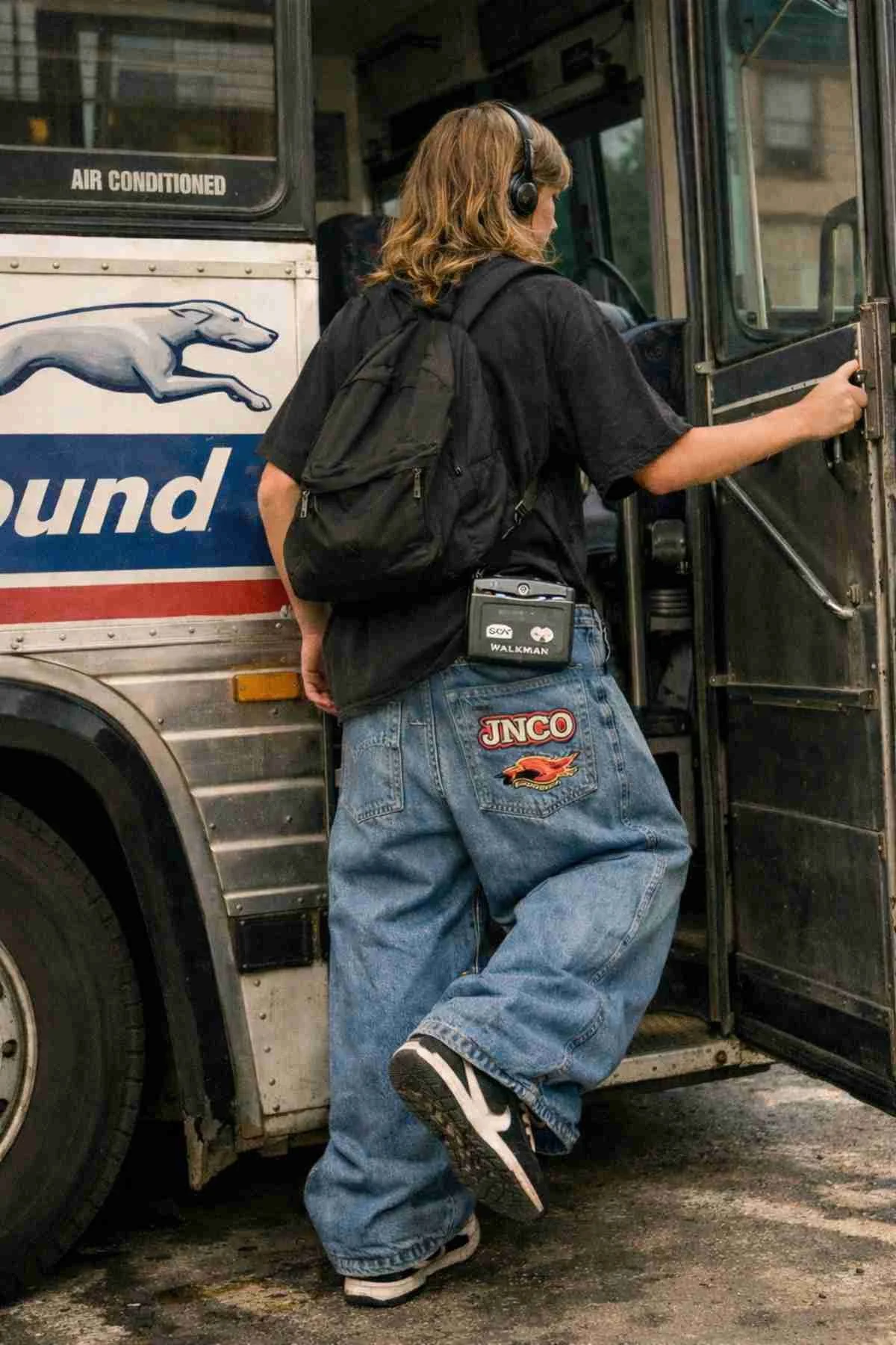 Teenager with long dirty blonde hair wearing 1990s headphones and a Walkman while boarding a bus, dressed in baggy JNCO jeans.
