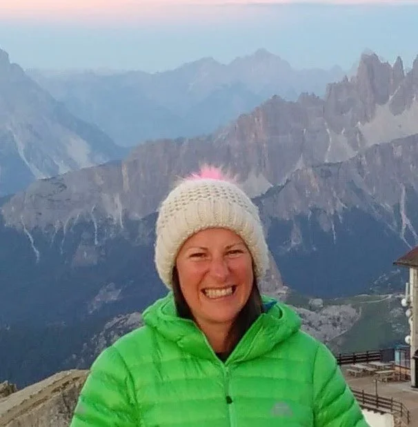 Photo of Diana in a wooly hat in front of mountains