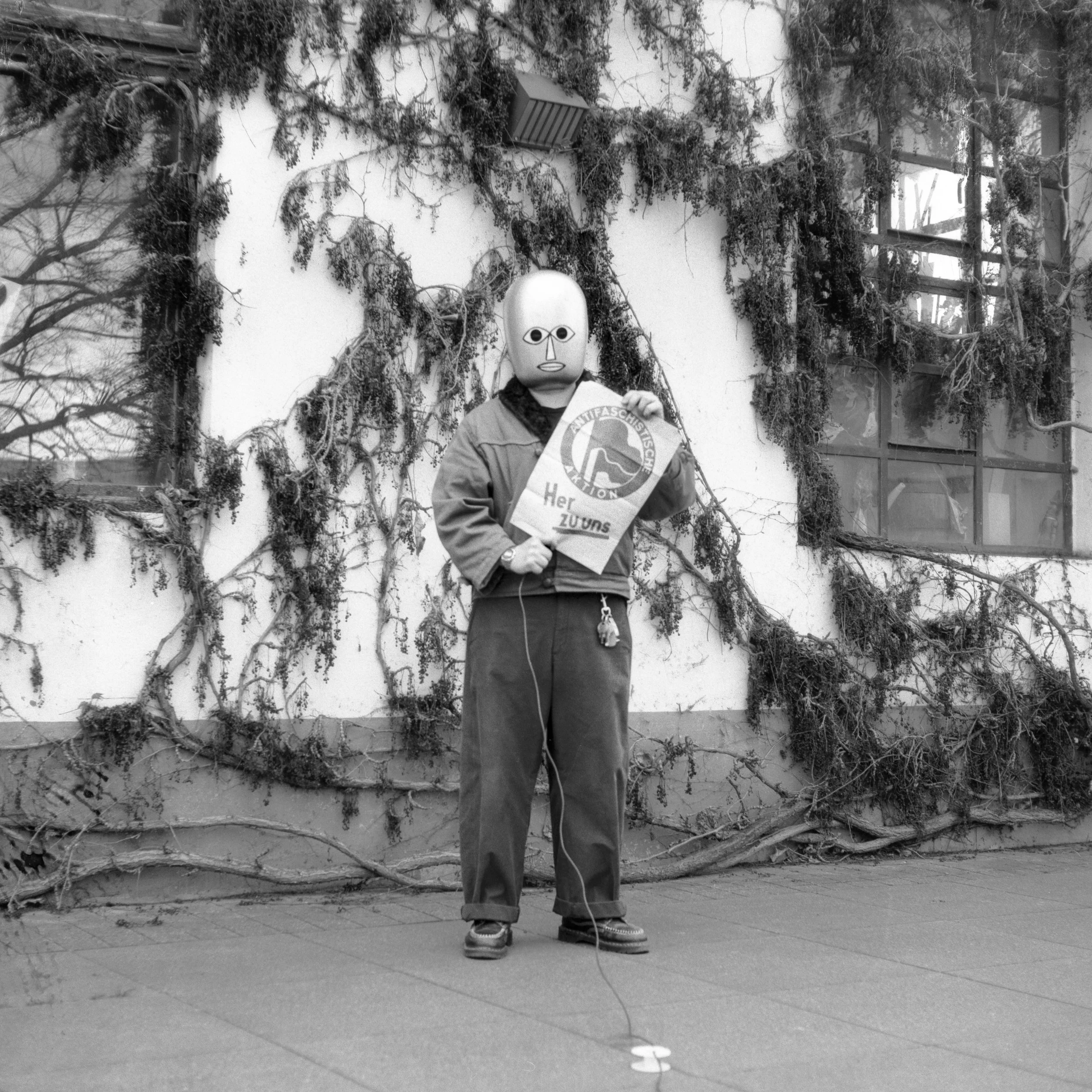 Self-Portrait as Bauhaus Ghost with Anti-Fascist Poster designed and used by Bauhaus Students, Bauhaus Dessau, Germany.