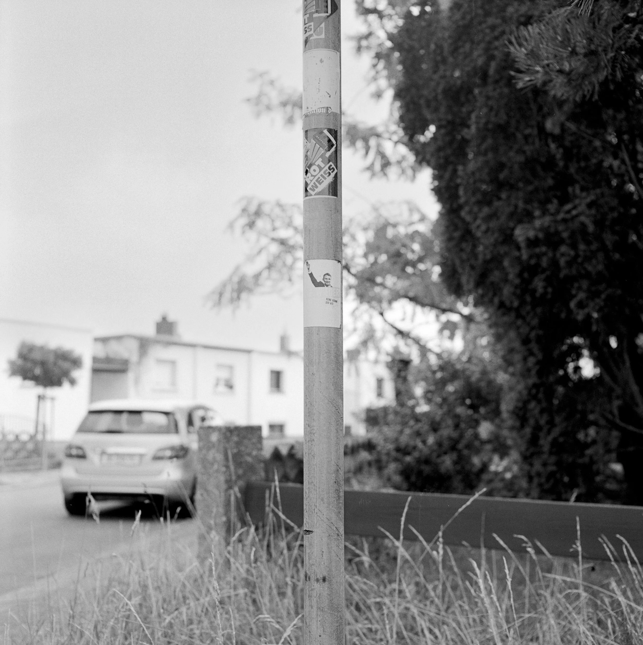 Sign post with Political Stickers. Torten Estate, Dessau, Germany.
