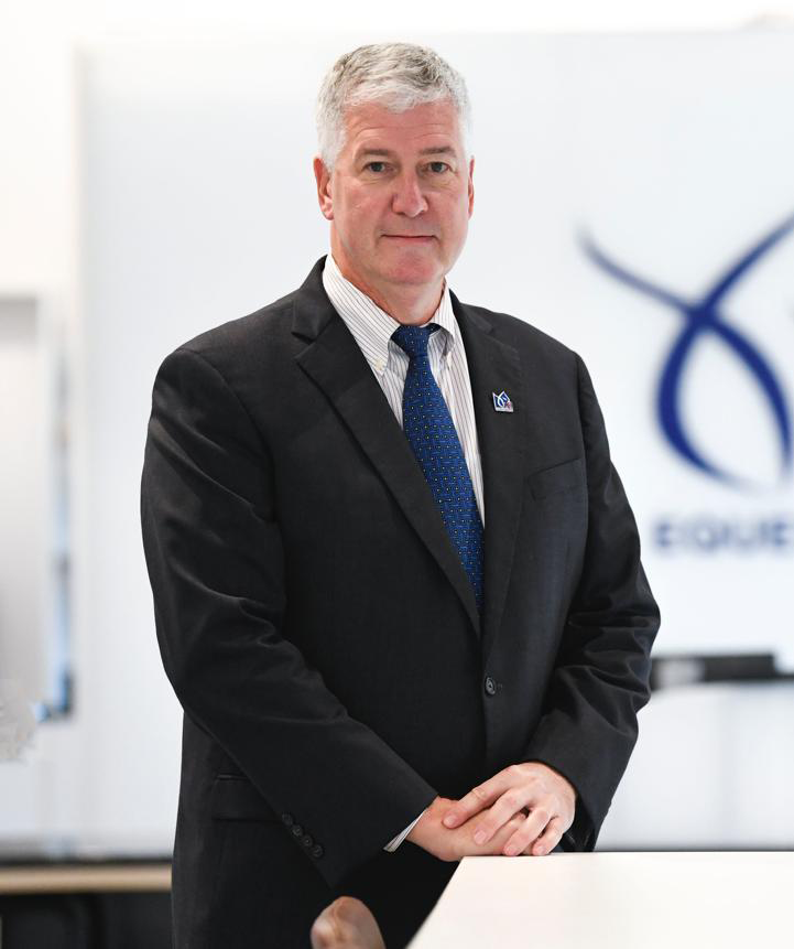 Older man in a suit and blue tie