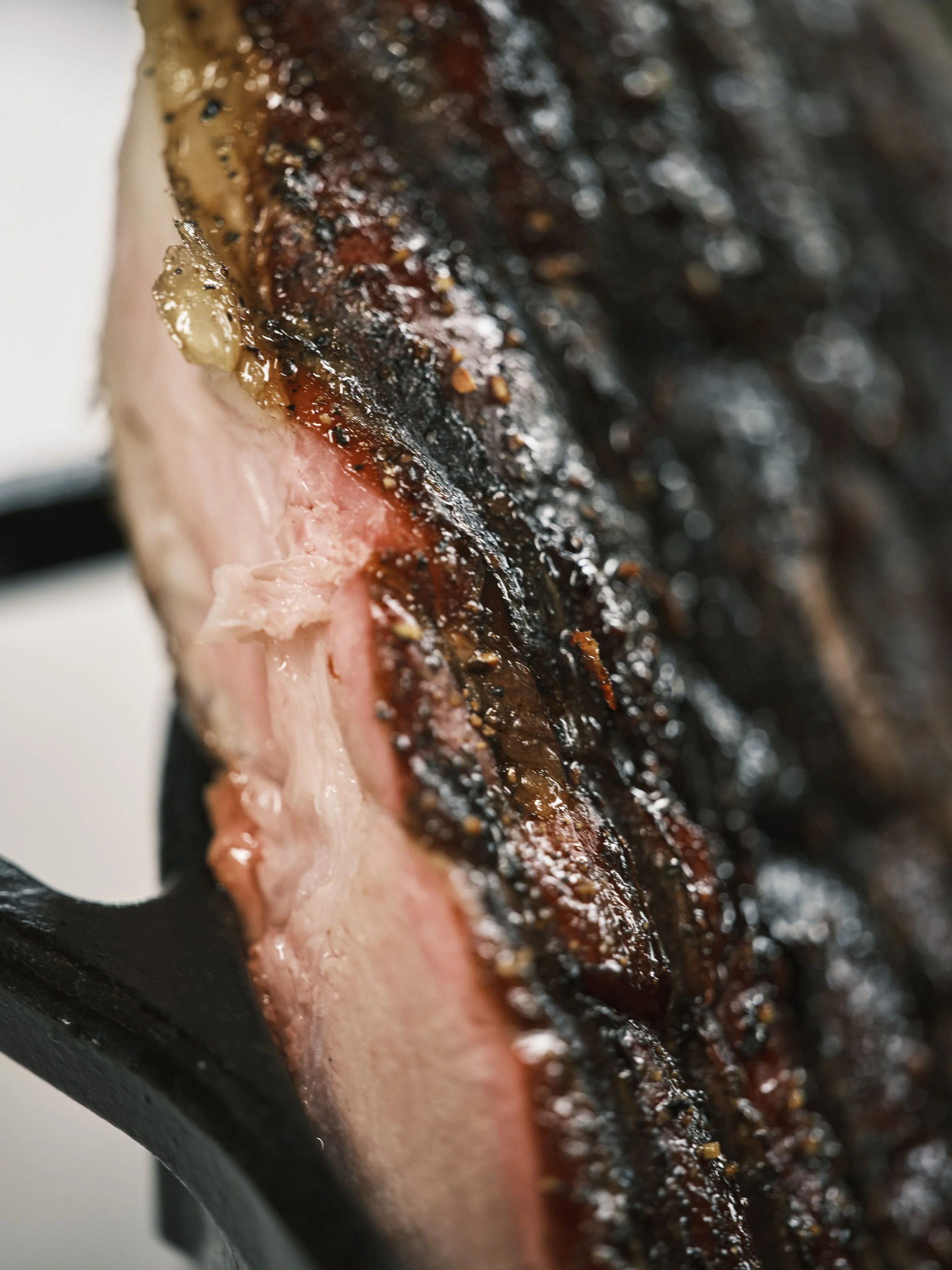 Close-up of a cooked steak with a charred exterior and a pink interior