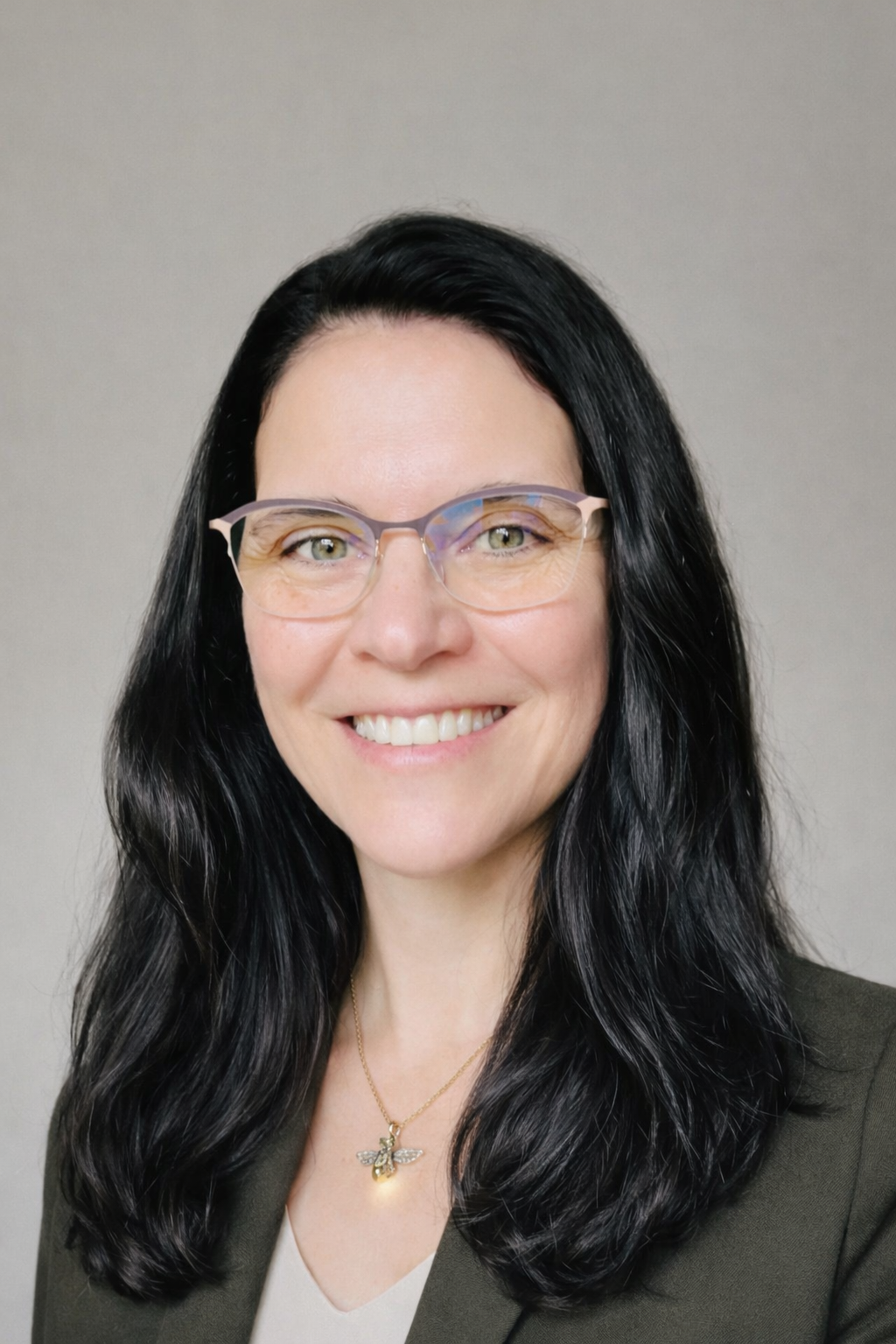 A woman with long dark hair and light skin smiling, with a white background and a label that reads "Born: 326 ppm."