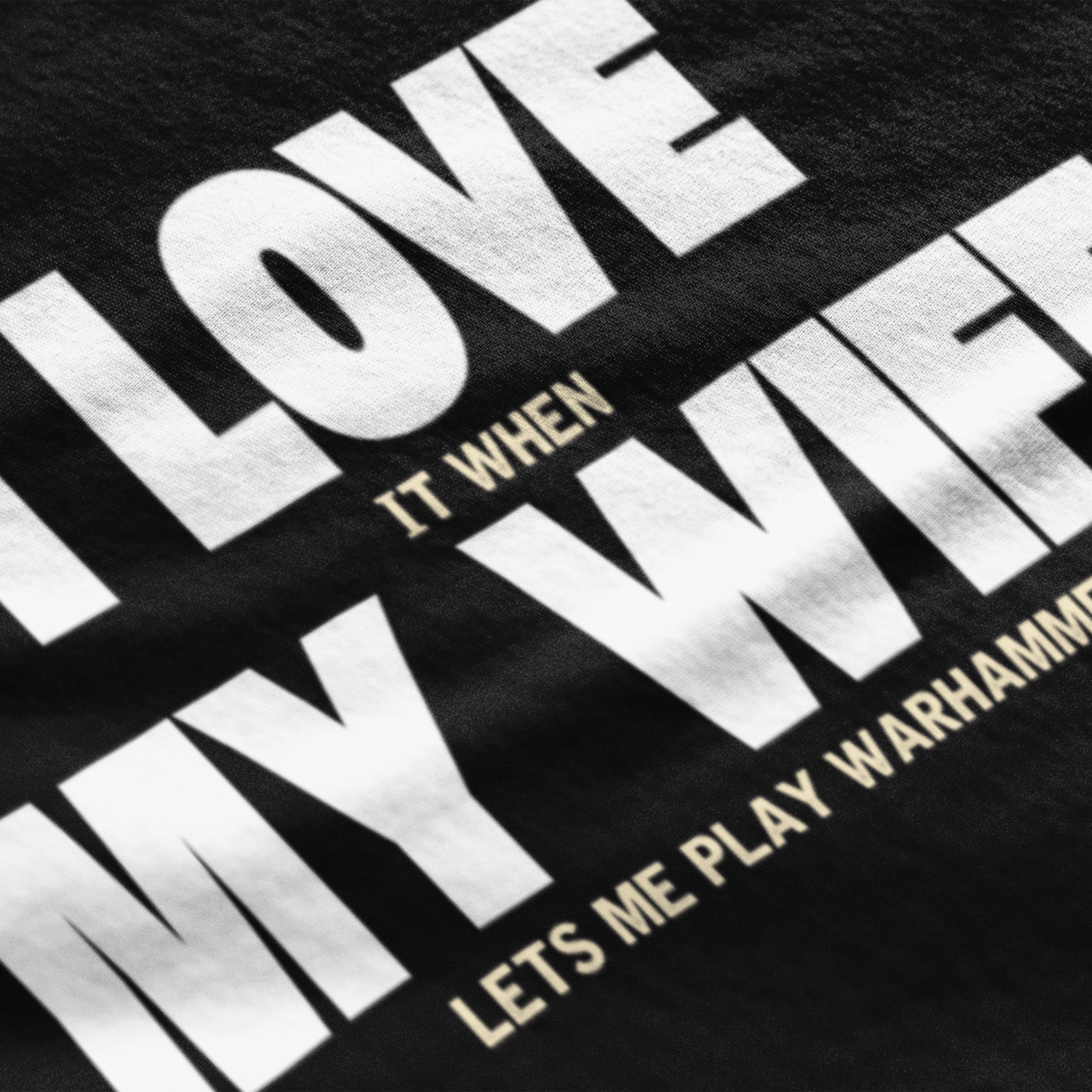close up of Funny Warhammer t-shirt for husbands with wording "I love it when my wife lets me play warhammer!"