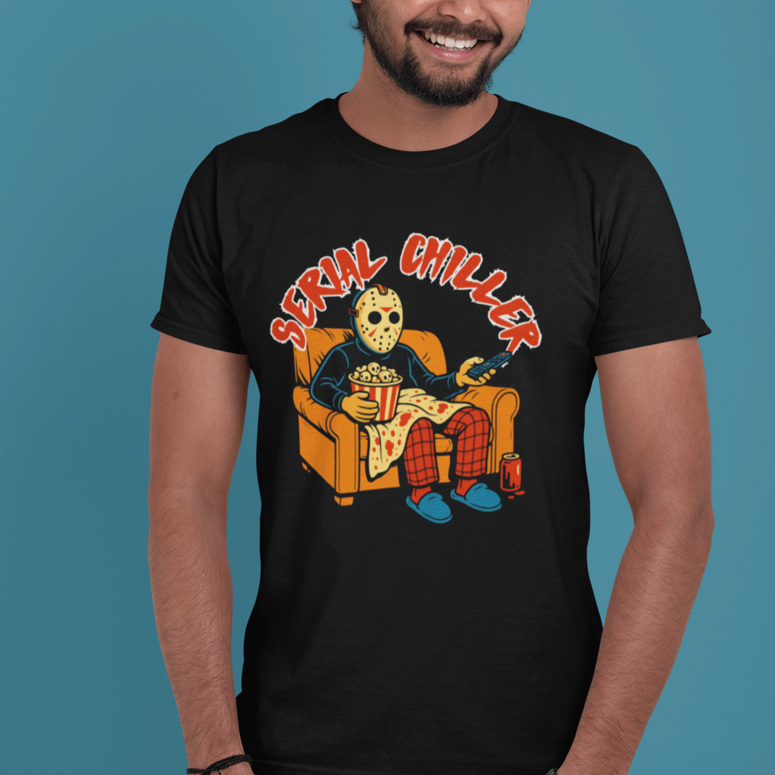 man smiling wearing horror movie lover t-shirt with jason vorhees watching slasher movies
