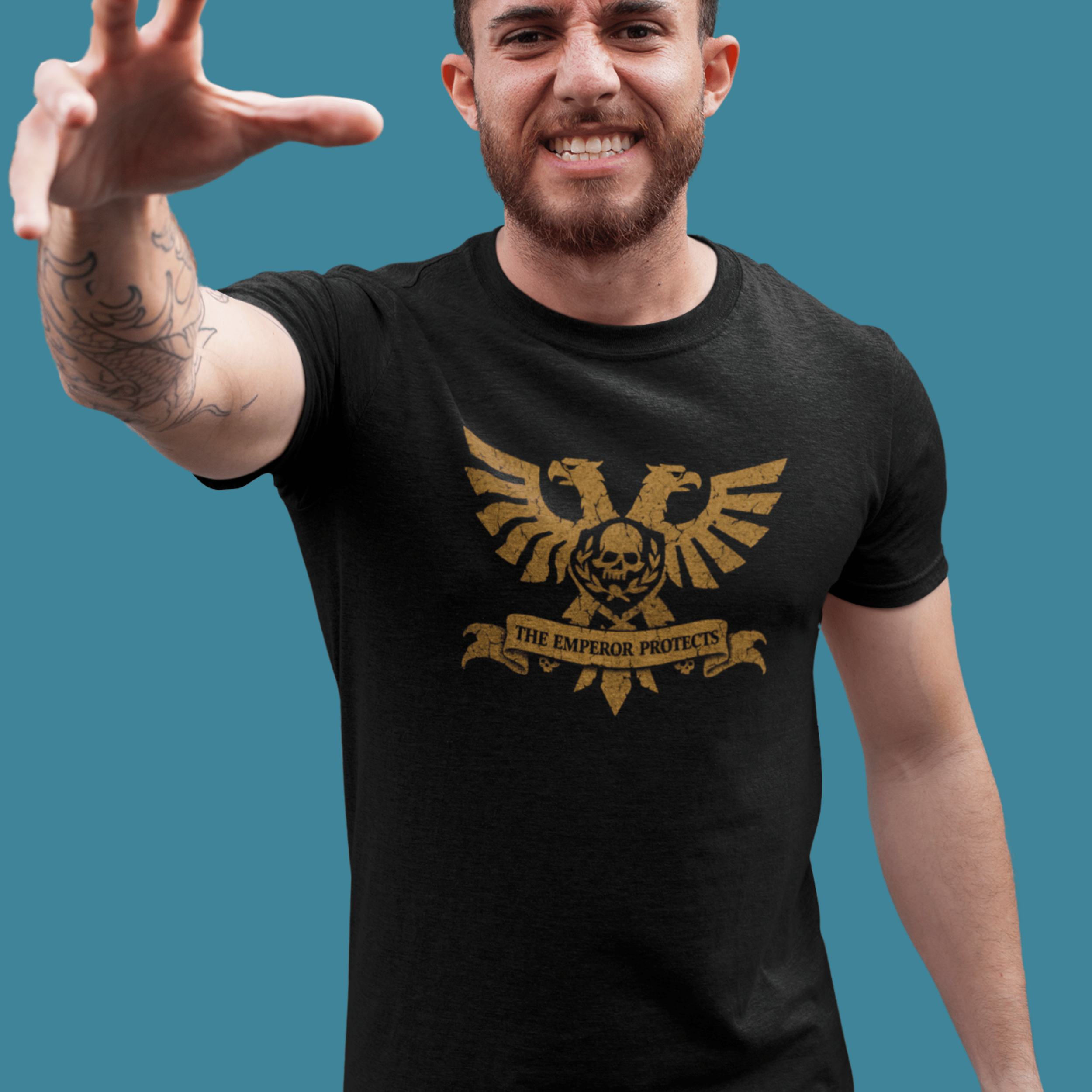 man smiling wearing Warhammer 40k tshirt with aquila and classic quote "the emperor protects"