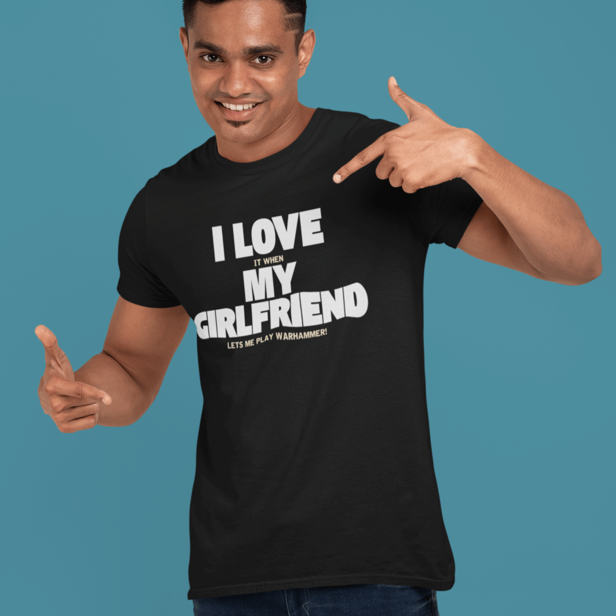 man smiling wearing Funny warhammer t-shirt for boyfriend with slogan "I love it when my girlfriend lets me play warhammer!"