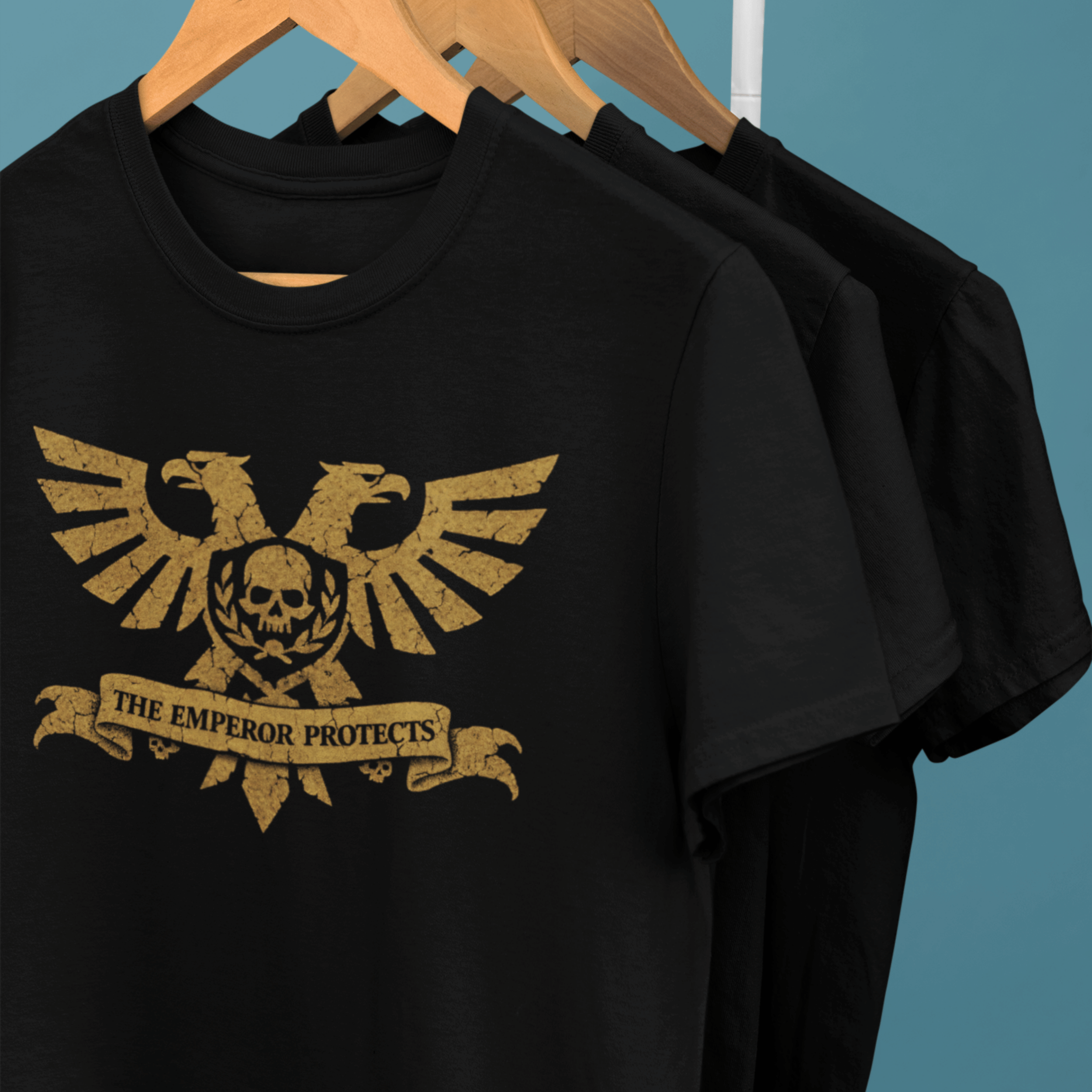 clothes rack of Warhammer 40k tshirts with aquila and classic quote "the emperor protects"