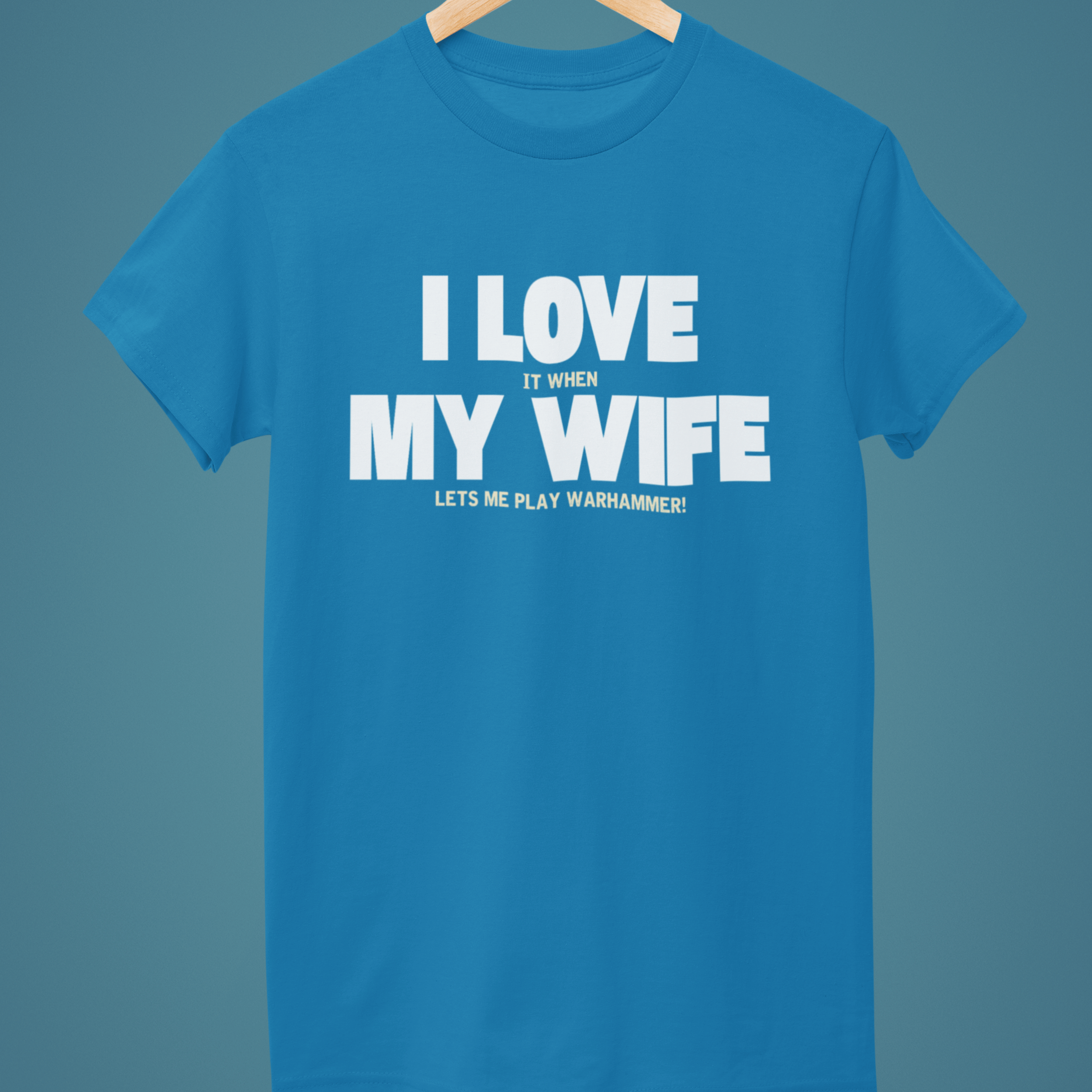 Blue Funny Warhammer t-shirt for husbands with wording "I love it when my wife lets me play warhammer!"