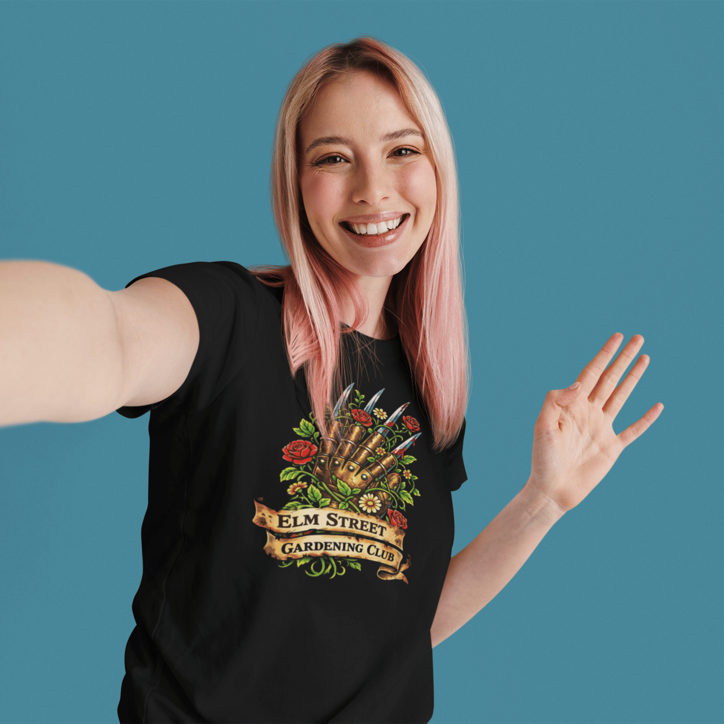 woman wearing Nightmare on Elm Street t-shirt with freddy's claw and "elm street gardening club" sign