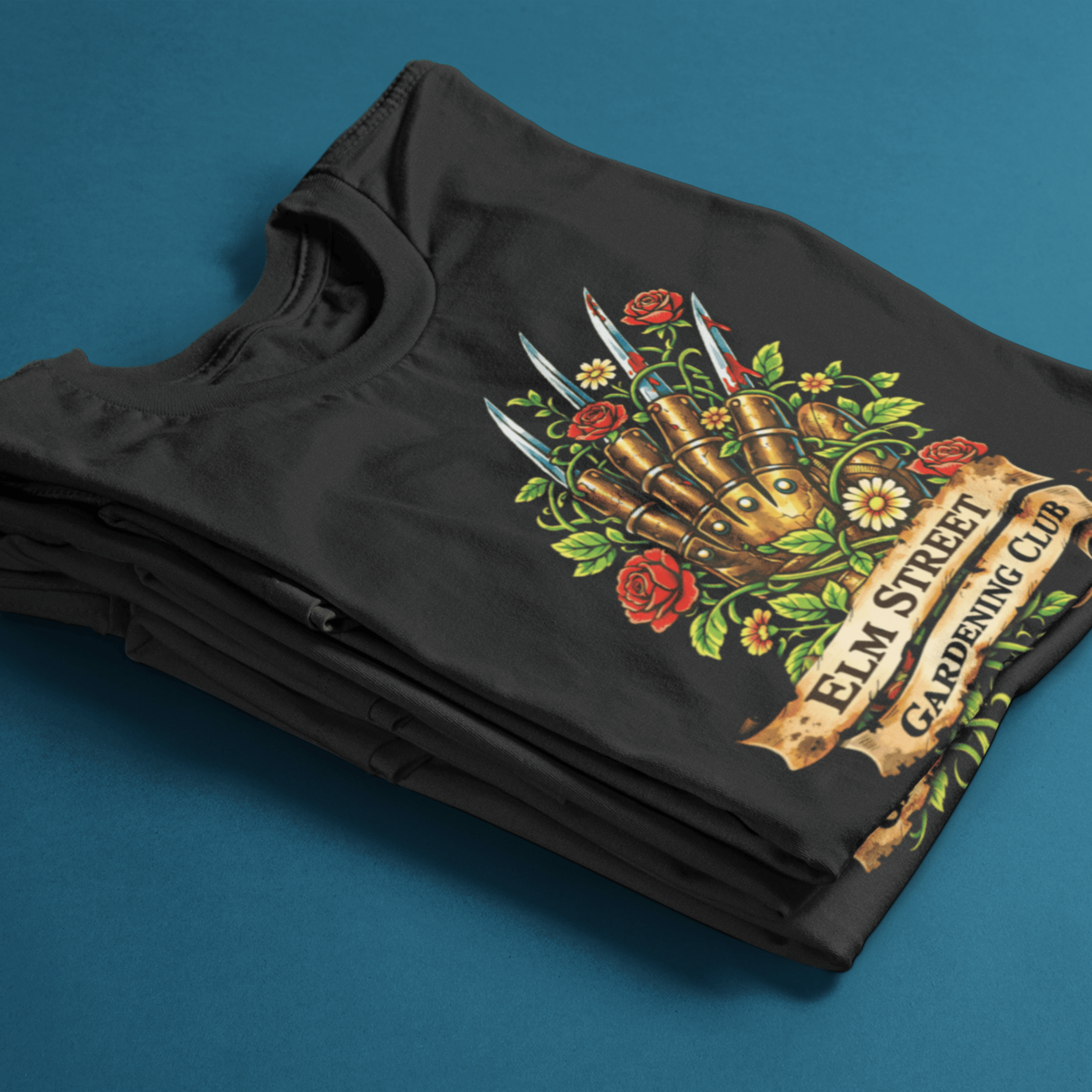 folded Nightmare on Elm Street t-shirt with freddy's claw and "elm street gardening club" sign