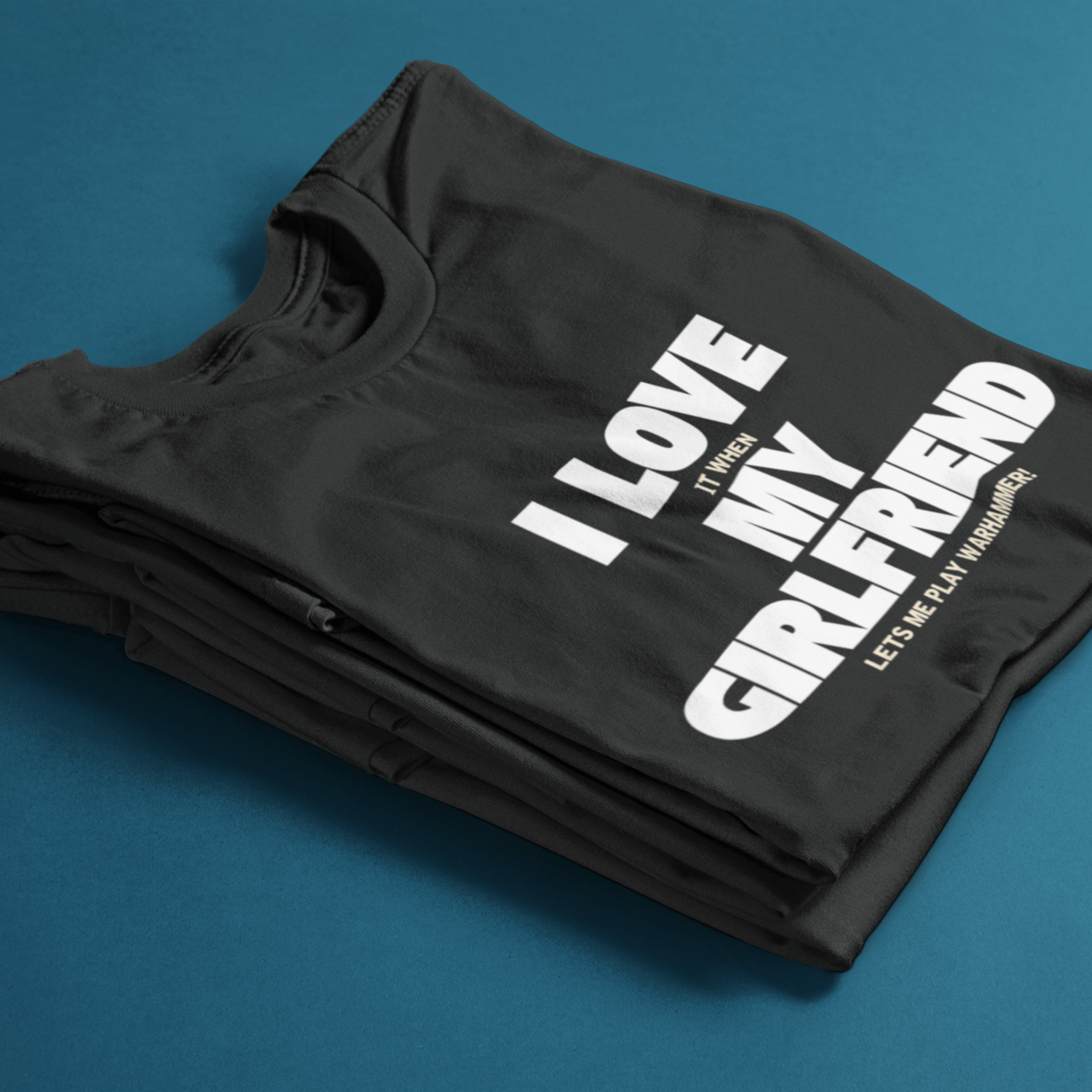folded Funny warhammer t-shirt for boyfriend with slogan "I love it when my girlfriend lets me play warhammer!"